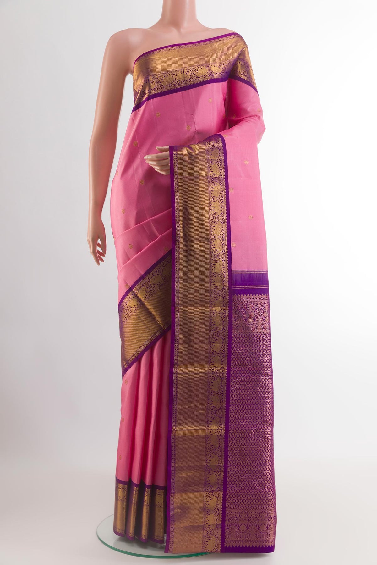 Rose pink Kanjivaram Silk Saree with Zari Butta on the body and Zari Border.  displayed on a mannequin