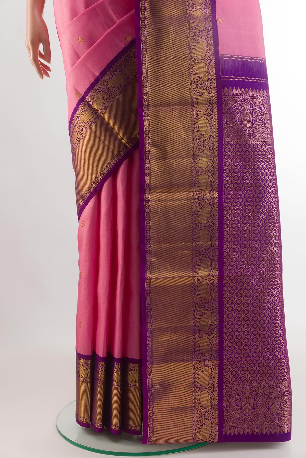 Pleats and pallu of Rose pink Kanjivaram Silk Saree with Zari Butta on the body and Zari Border. 