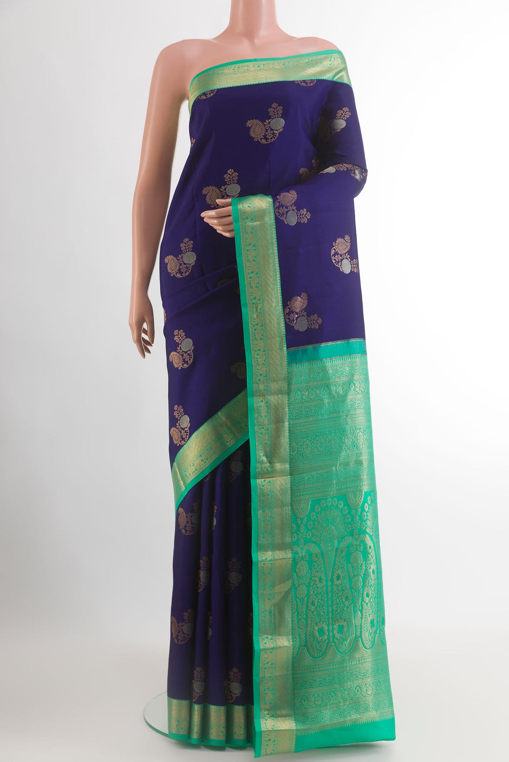 Navy Blue Kanjivaram Silk Saree with Zari Butta on the body and Zari Border.  displayed on a mannequin