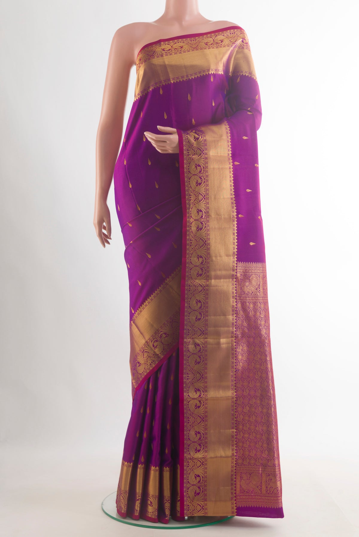 Pure Silk Purple Kanchipuram Saree with Zari Butta on the body and Zari Border.  displayed on a mannequin