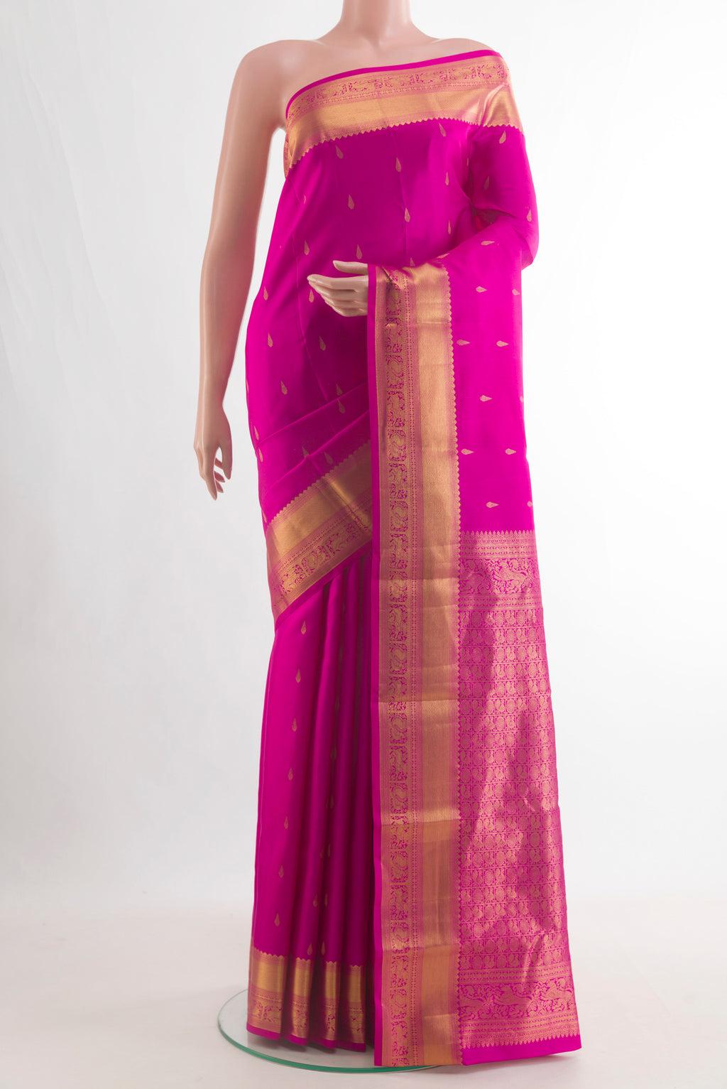 Pure Silk Pink Kanchipuram Saree with Zari Butta on the body and Zari Border.  displayed on a mannequin