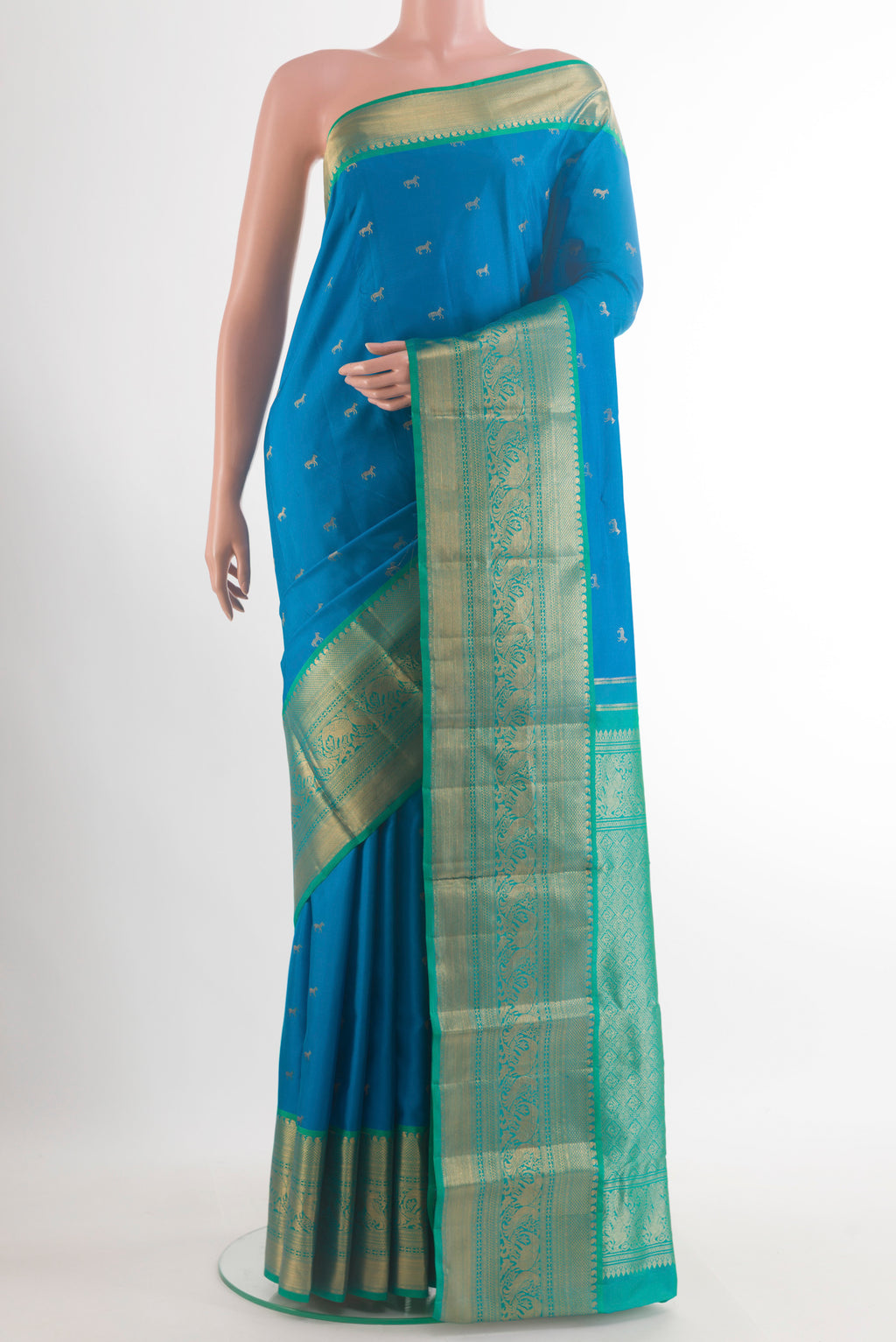 Pure Silk Blue Kanchipuram Saree with Zari Butta on the body and Zari Border.  displayed on a mannequin