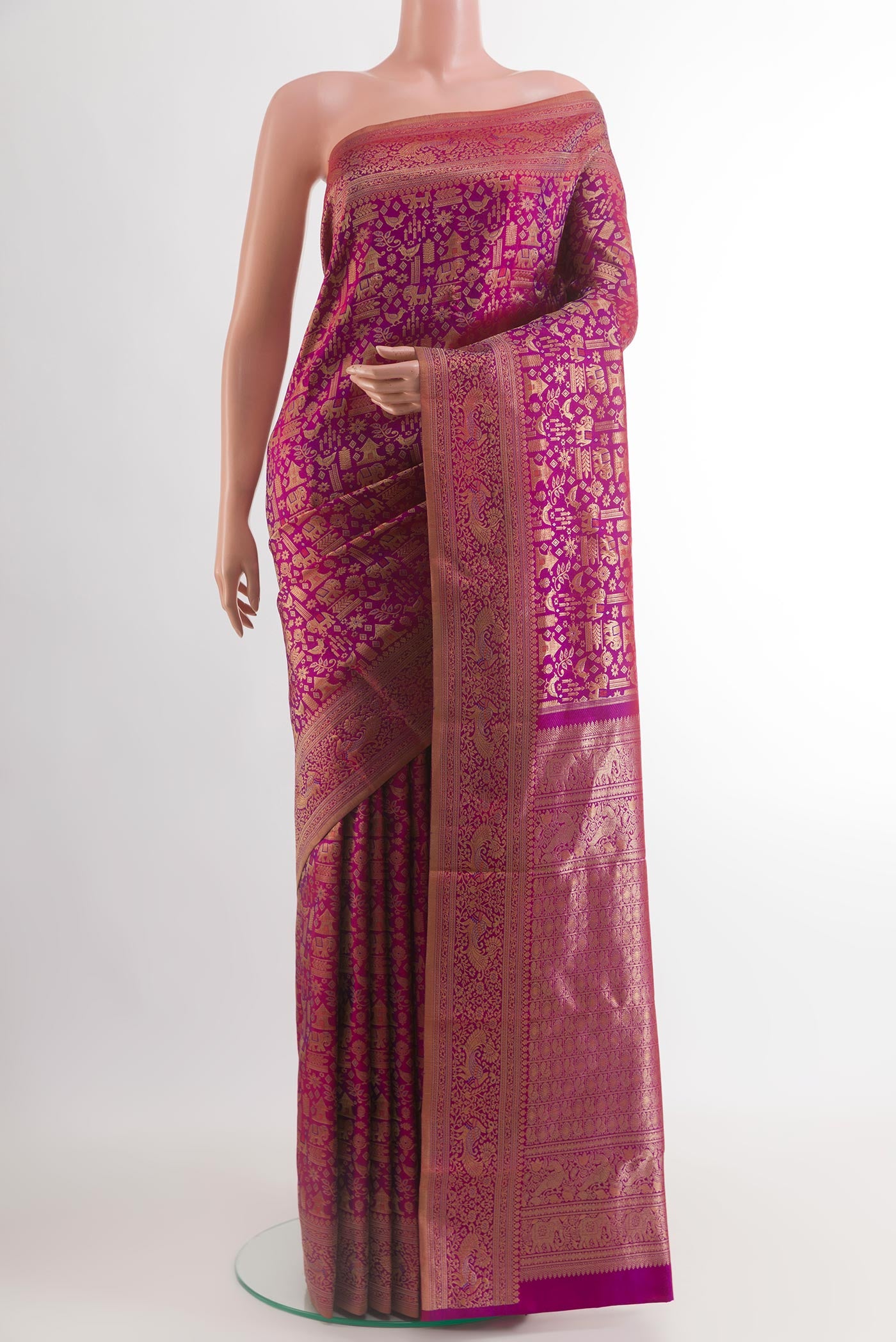 Magenta Kanchipuram Silk Saree with Zari Brocade on the body and Zari Border.  displayed on a mannequin