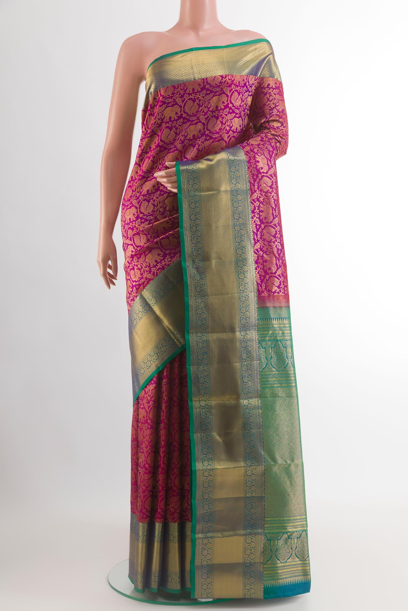 Magenta Kanchipuram Silk Saree with Zari Brocade on the body and Zari Border.  displayed on a mannequin