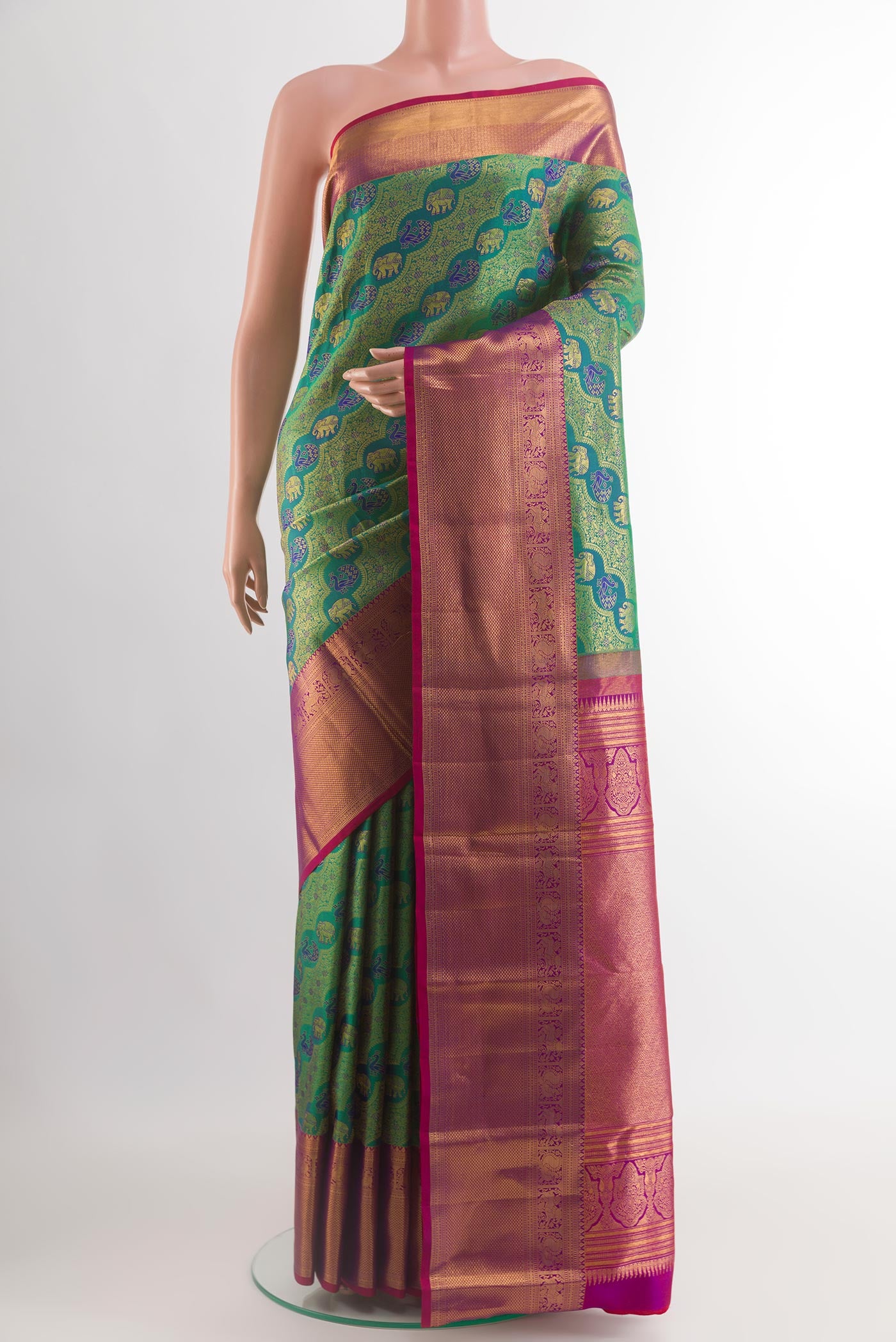 Green Kanchipuram Silk Saree with Zari Brocade on the body and Zari Border.  displayed on a mannequin