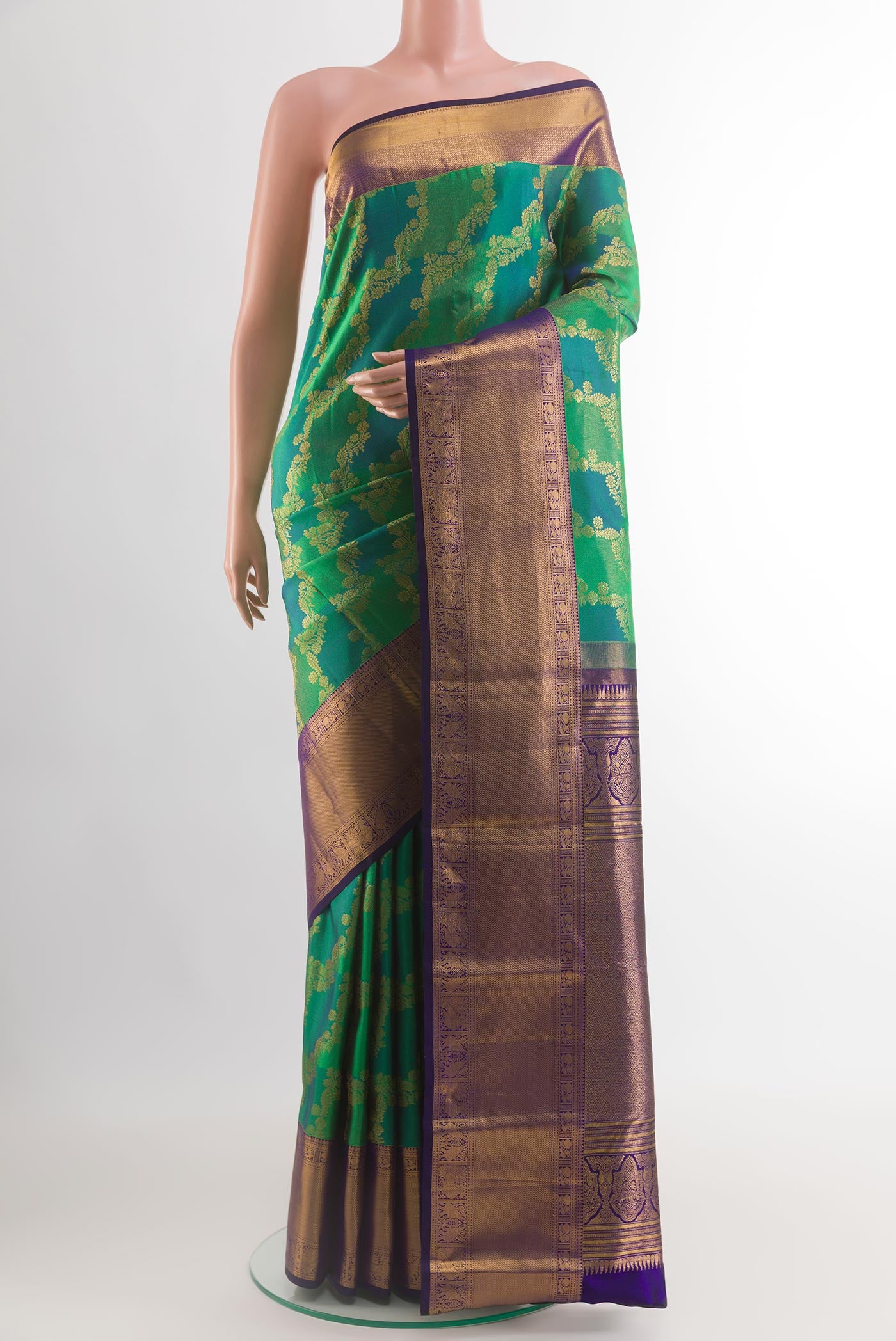 Green Kanchipuram Silk Saree with Zari Brocade on the body and Zari Border.  displayed on a mannequin