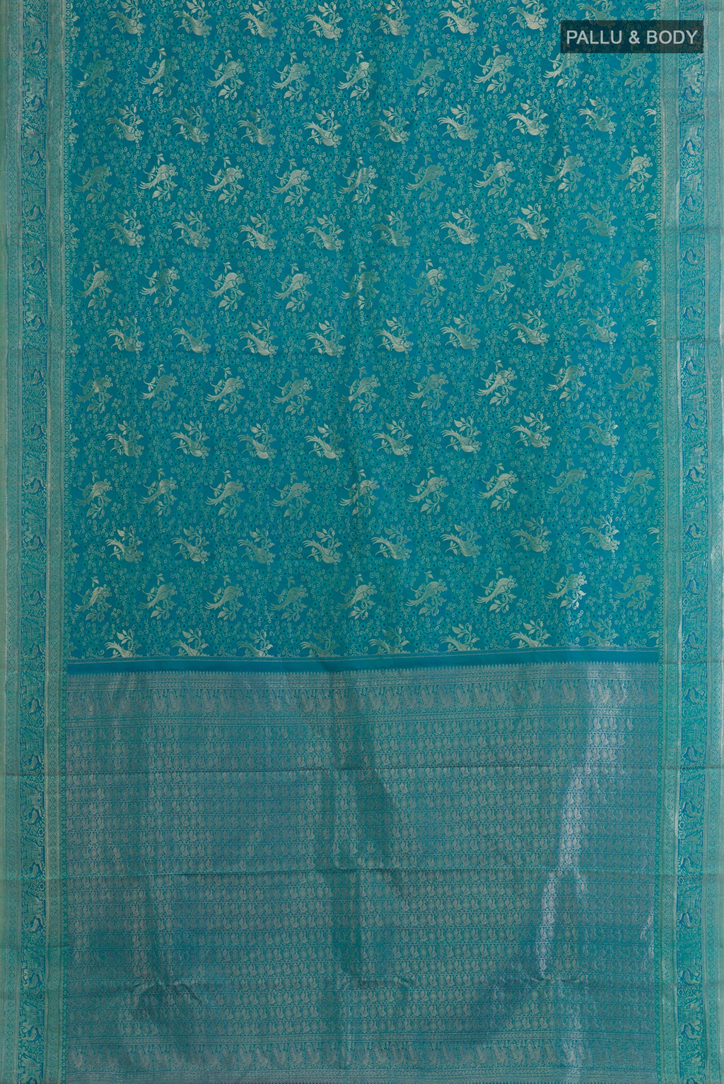 Flat view of Peacock Blue Kanjivaram Silk Saree with Zari Brocade on the body and Zari Border. 