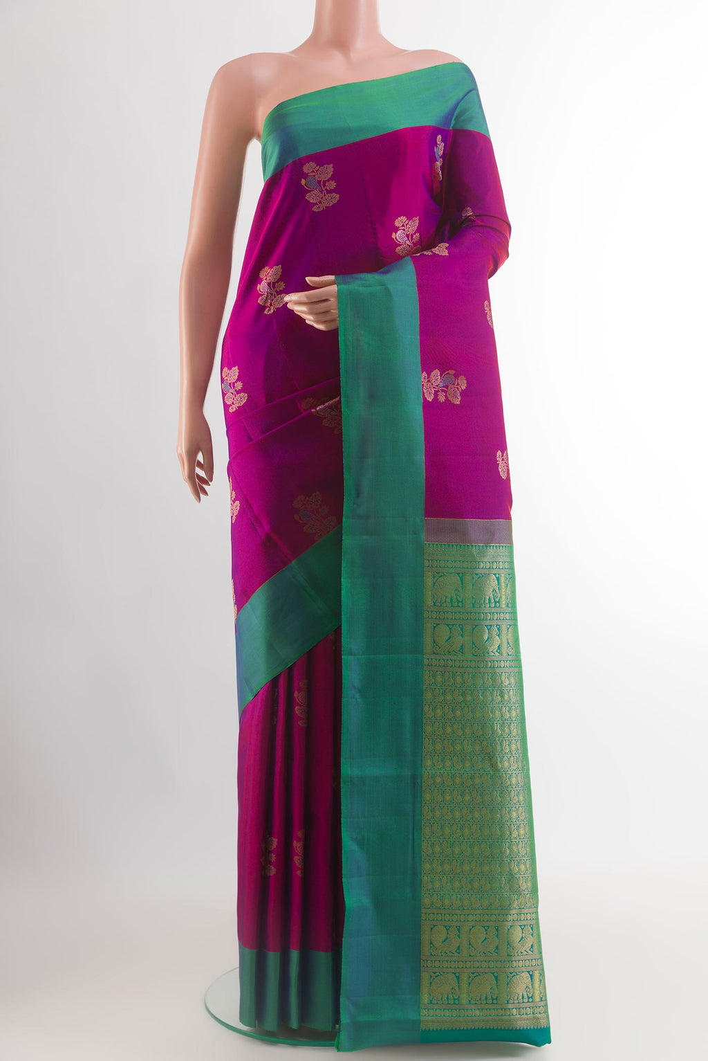 Magenta Kanjivaram Silk Saree with Zari Butta on the body and Plain Border.  displayed on a mannequin