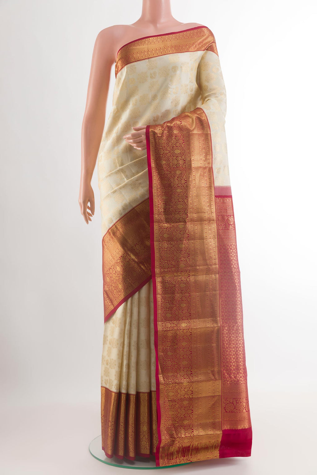 Off White Kanchipuram Silk Saree with Zari Brocade on the body and Zari Border.  displayed on a mannequin