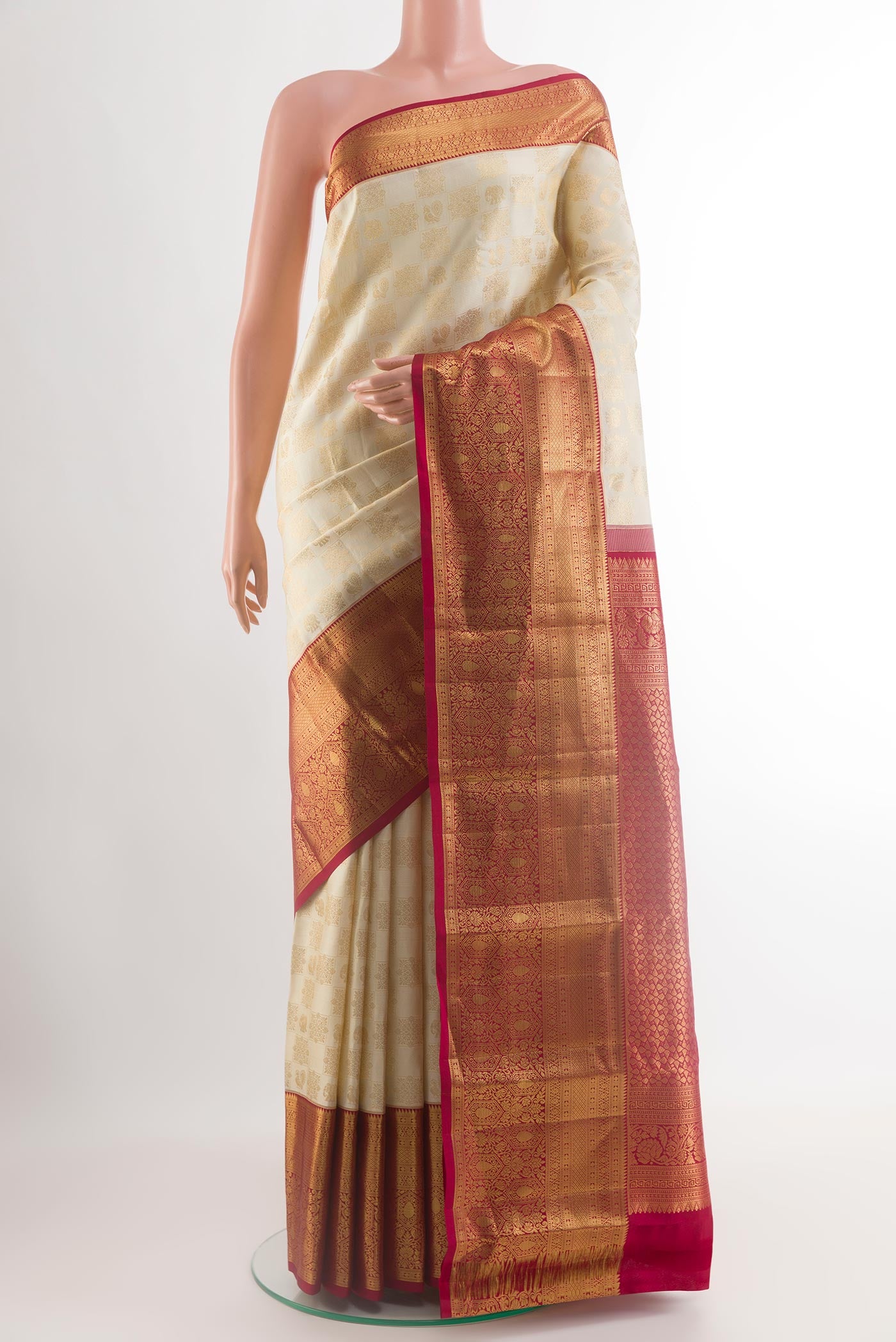 Off White Kanchipuram Silk Saree with Zari Brocade on the body and Zari Border.  displayed on a mannequin