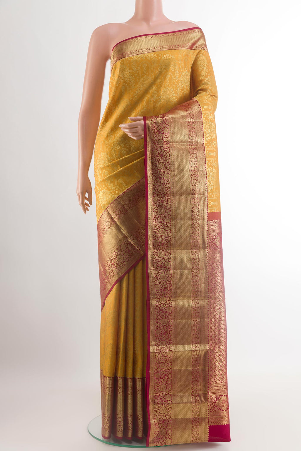 Yellow Kanchipuram Silk Saree with Zari Brocade on the body and Zari Border.  displayed on a mannequin