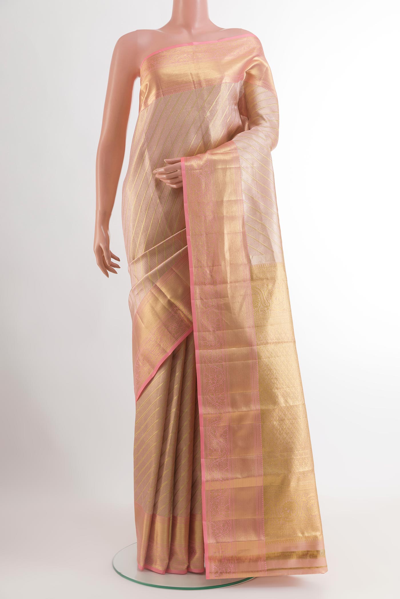 Rose Gold Kanchipuram Tissue Silk Saree with Zari Brocade on the body and Zari Border.  displayed on a mannequin