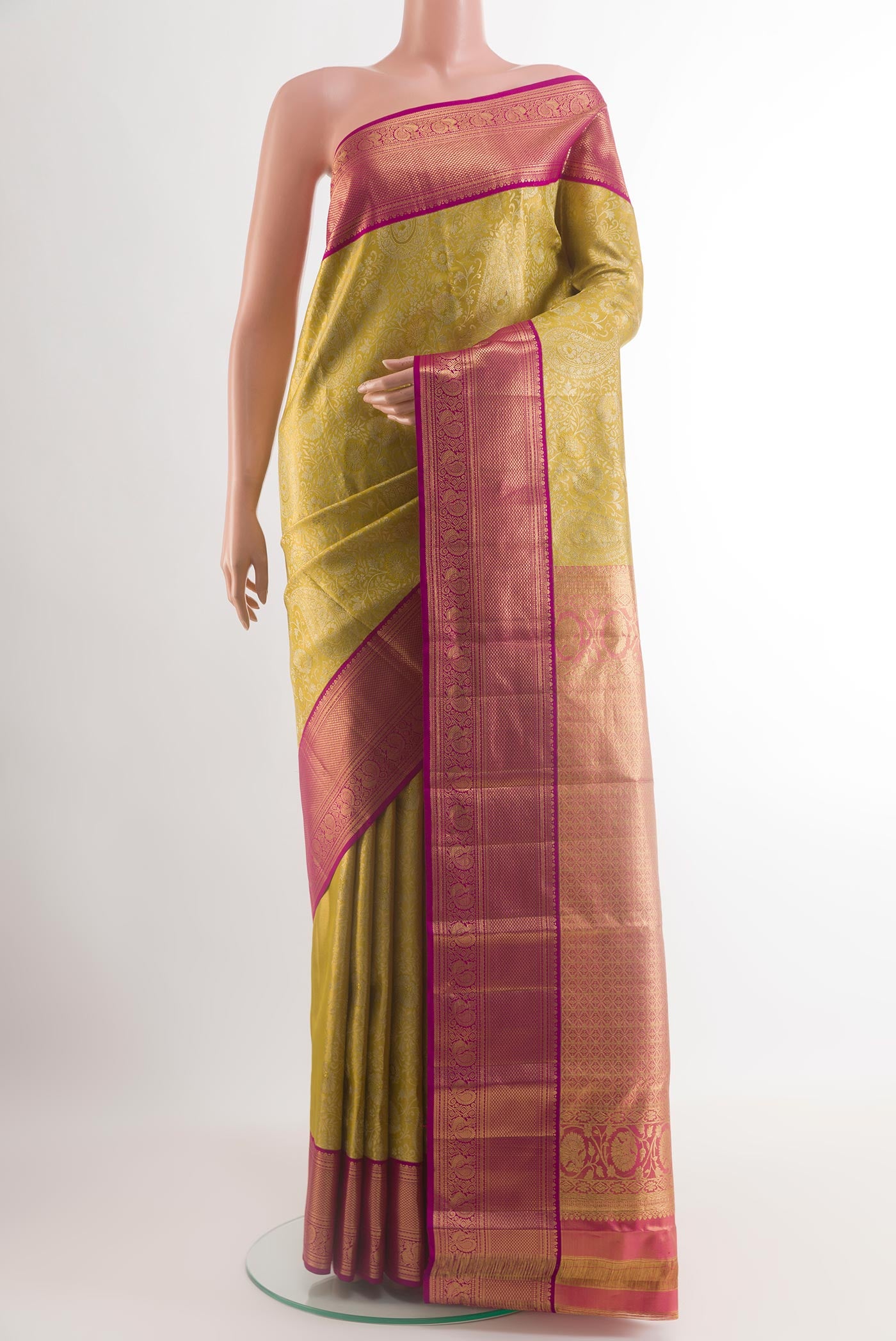 Golden Kanchipuram Silk Saree with Zari Brocade on the body and Zari Border.  displayed on a mannequin