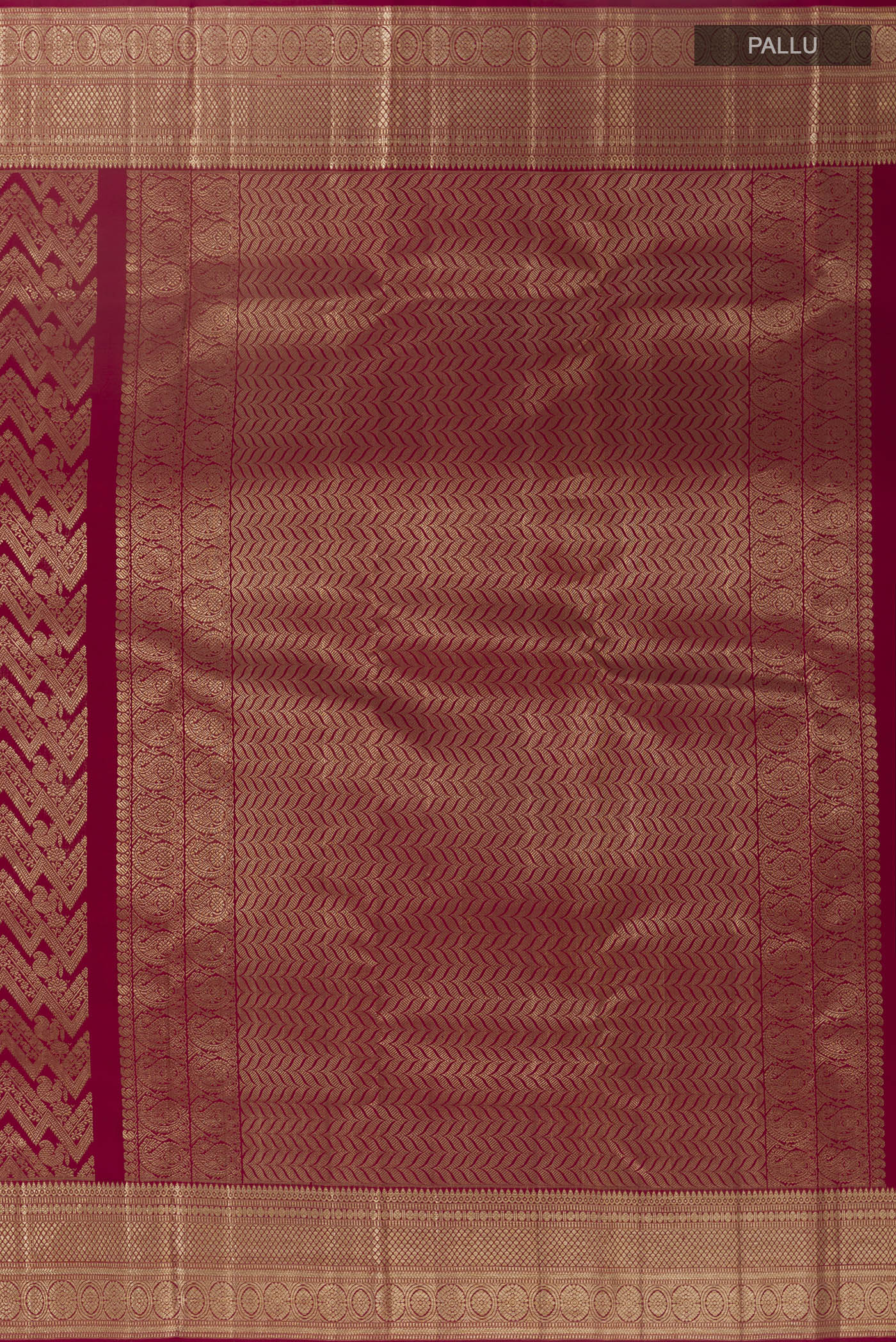 Close up image of the pallu of Maroon Kanchipuram Silk Saree with Zari Brocade on the body and Zari Border. 