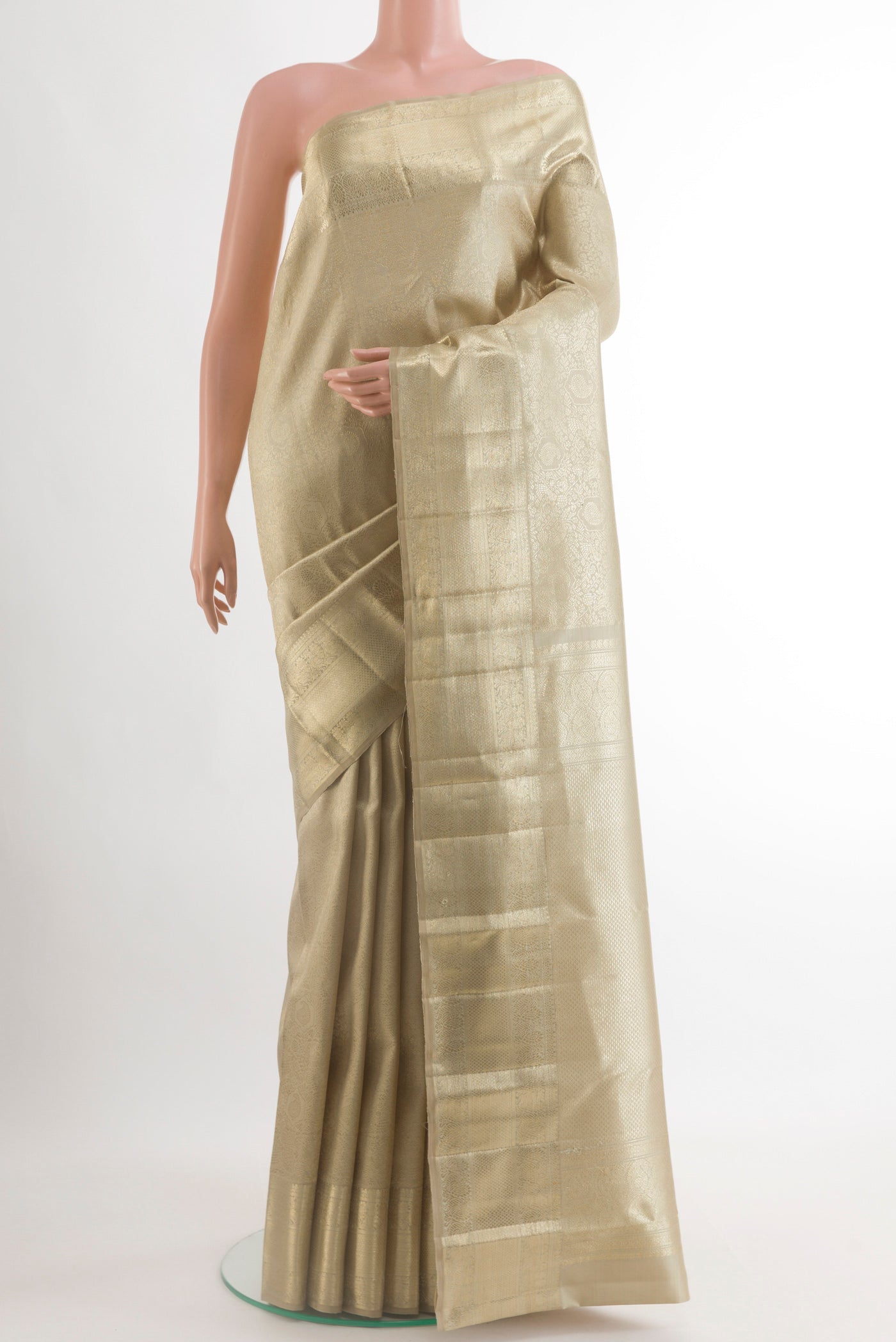 Beige Kanchipuram Silk Saree with Zari Brocade on the body and Zari Border.  displayed on a mannequin