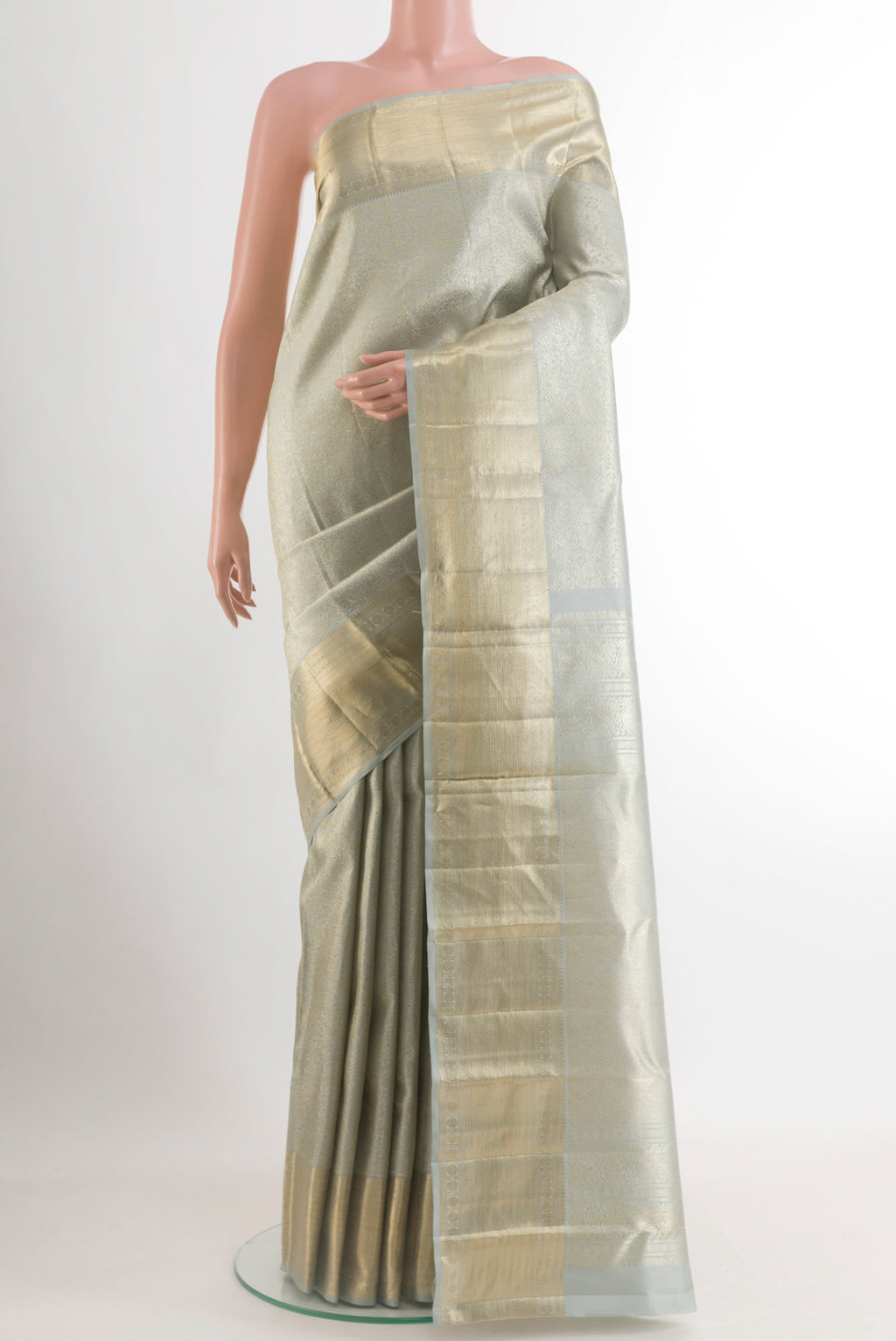 Grey Kanchipuram Silk Saree with Zari Brocade on the body and Zari Border.  displayed on a mannequin