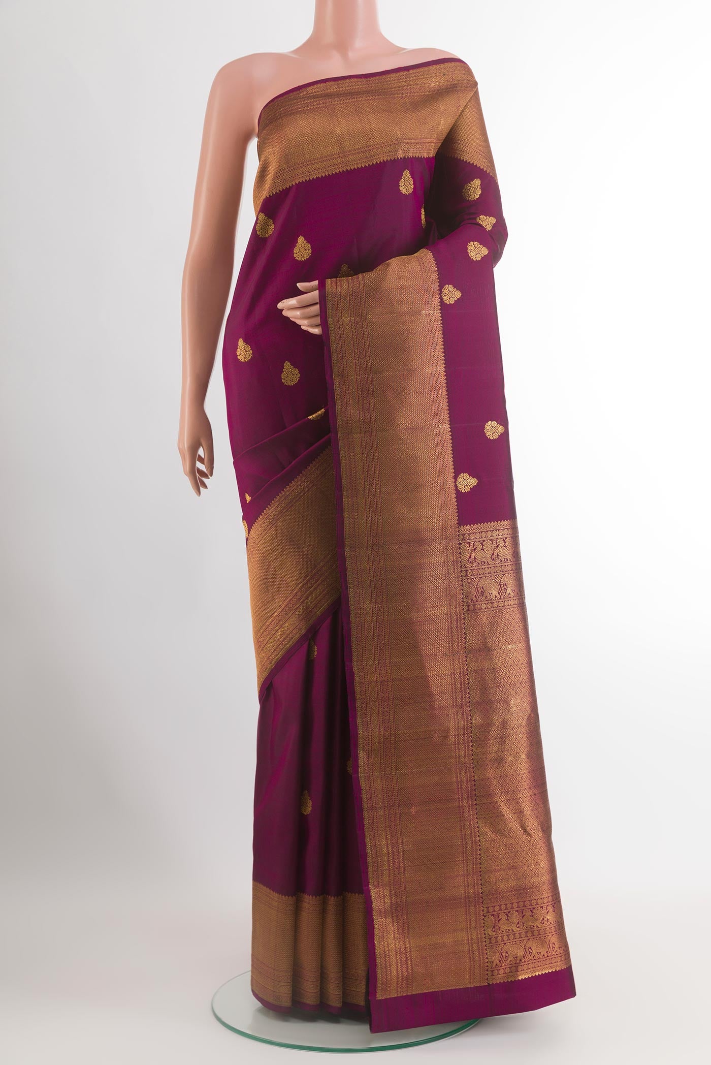 Purple Kanchipuram Silk Saree with Zari Butta on the body and Zari Border.  displayed on a mannequin