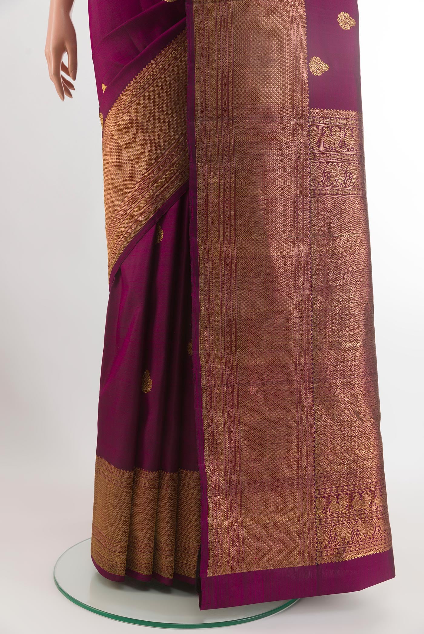 Pleats and pallu of Purple Kanchipuram Silk Saree with Zari Butta on the body and Zari Border. 