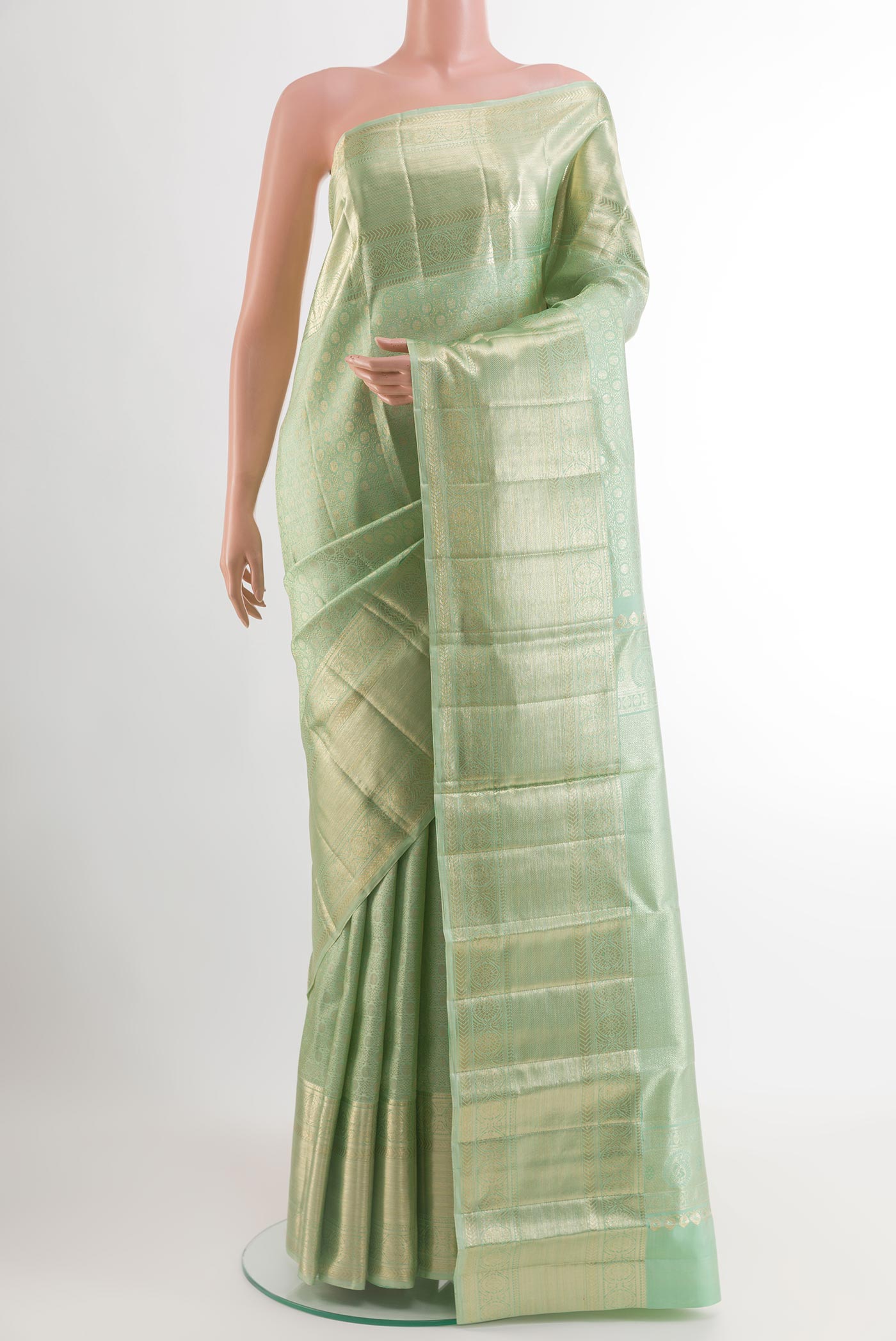 Mint Green Kanchipuram Tissue Silk Saree with Zari Brocade on the body and Zari Border.  displayed on a mannequin