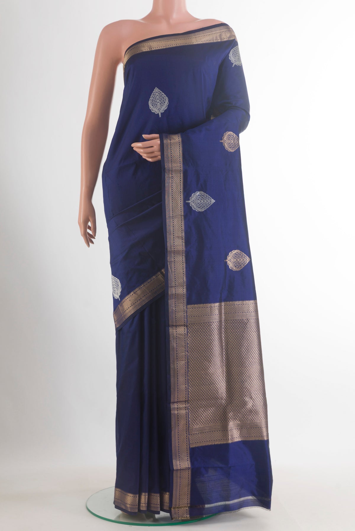 Pure Silk Navy Blue Banarasi Katan Saree with Zari Butta on the body and Zari Border.  displayed on a mannequin