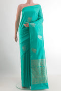Turquoise Banarasi Katan Silk Saree with Zari Butta on the body and Without Border.  displayed on a mannequin