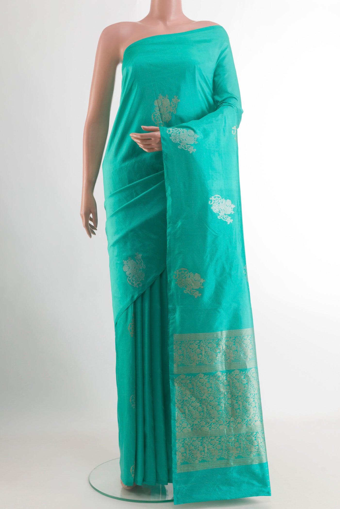 Turquoise Banarasi Katan Silk Saree with Zari Butta on the body and Without Border.  displayed on a mannequin