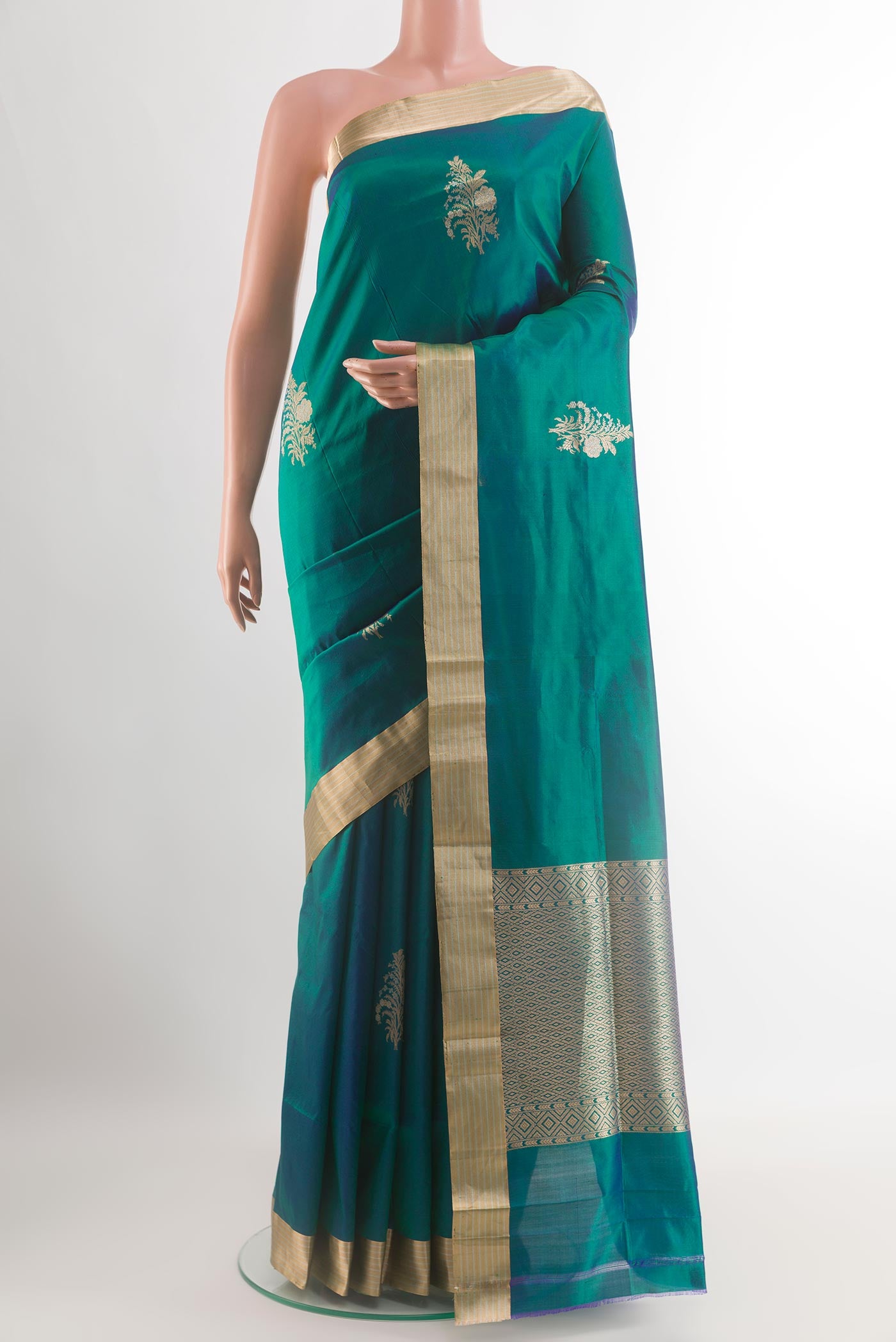 Peacock Blue Banarasi Katan Silk Saree with Zari Butta on the body and Zari Border.  displayed on a mannequin