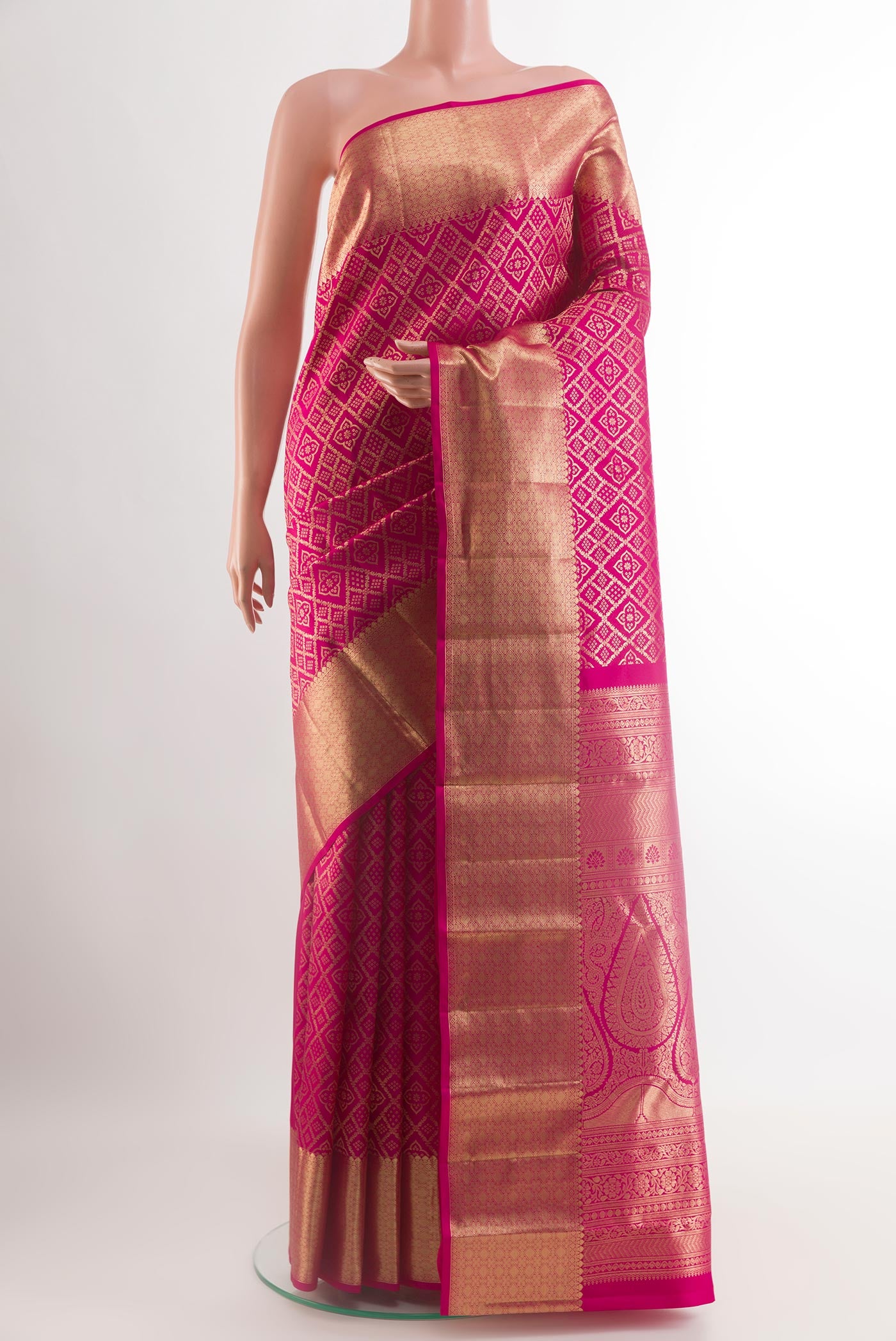 Rani Pink Kanchipuram Silk Saree with Zari Brocade on the body and Zari Border.  displayed on a mannequin