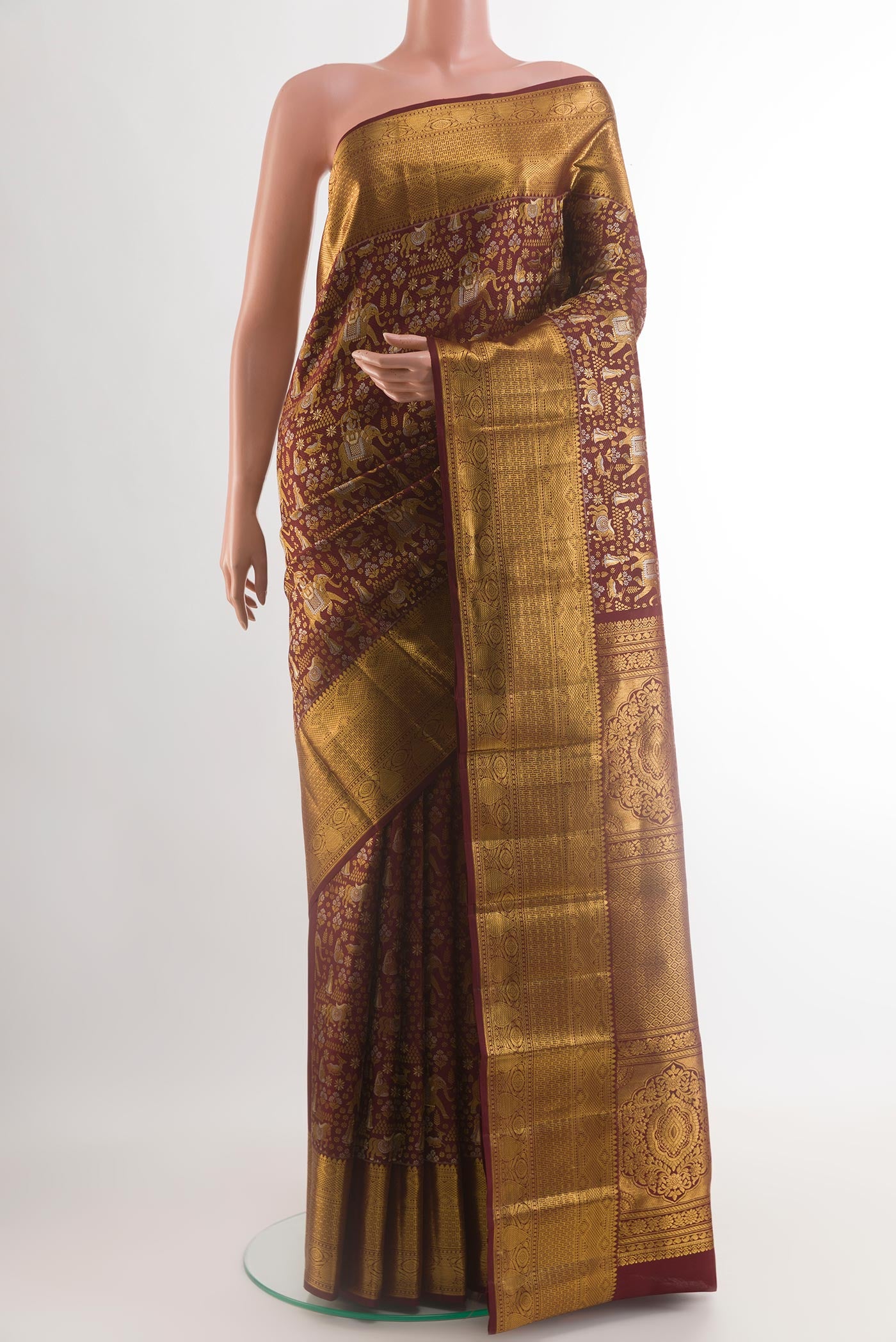 Brown Kanjivaram Silk Saree with Zari Brocade on the body and Zari Border.  displayed on a mannequin