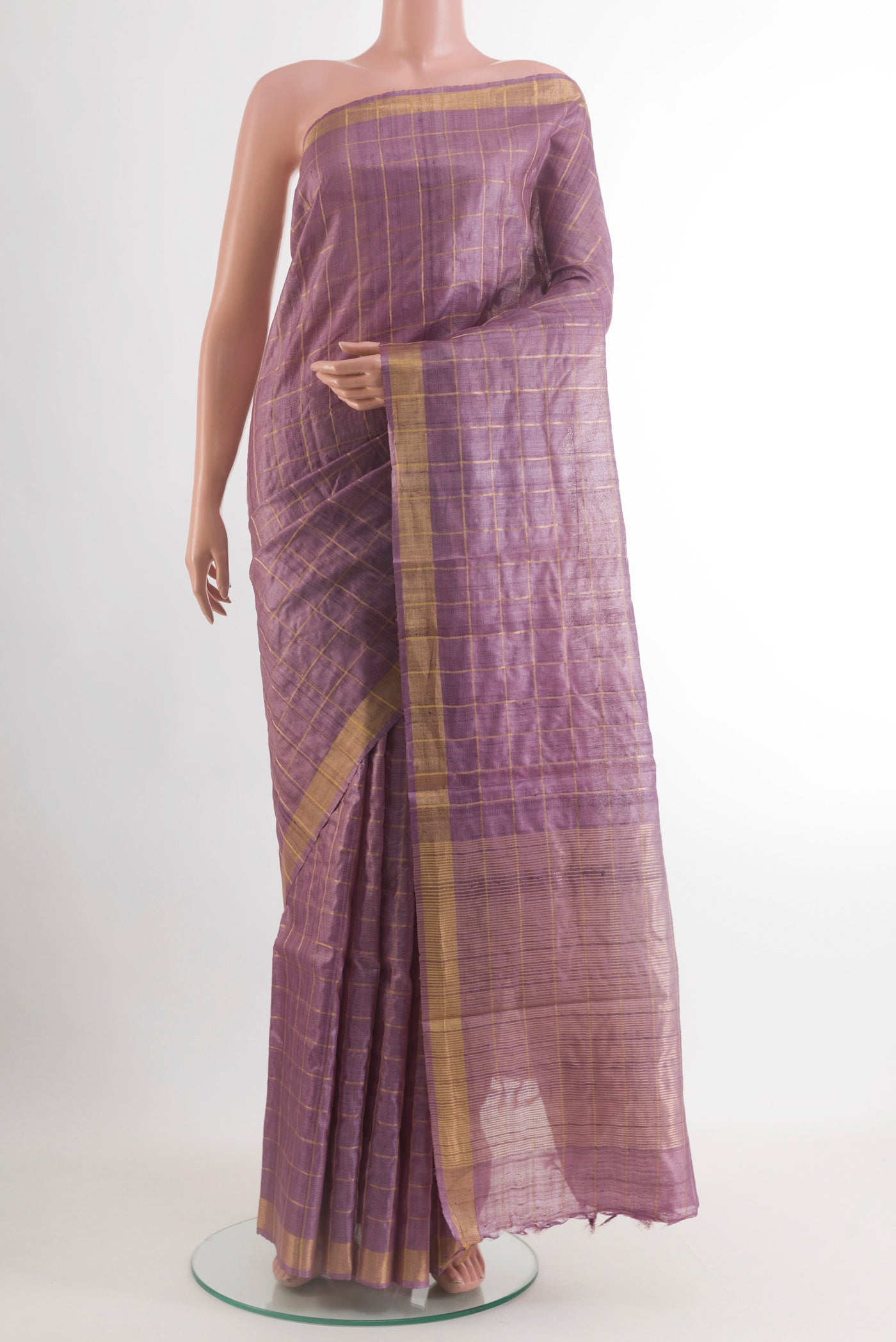 Lavender Tussar Silk Saree with Checked design on the body and Zari Border.  displayed on a mannequin