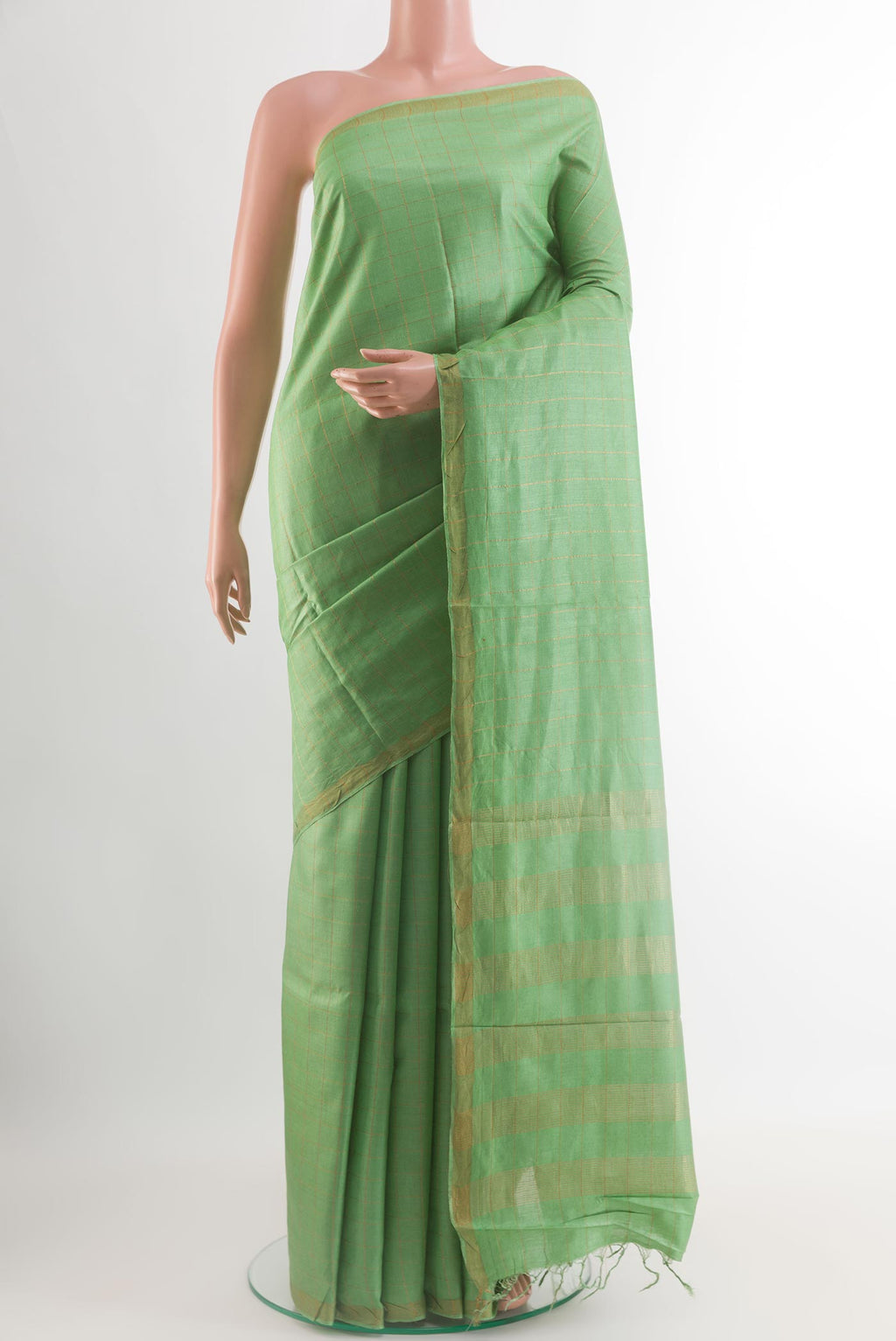 Light Green Tussar Silk Saree with Checked design on the body and Zari Border.  displayed on a mannequin