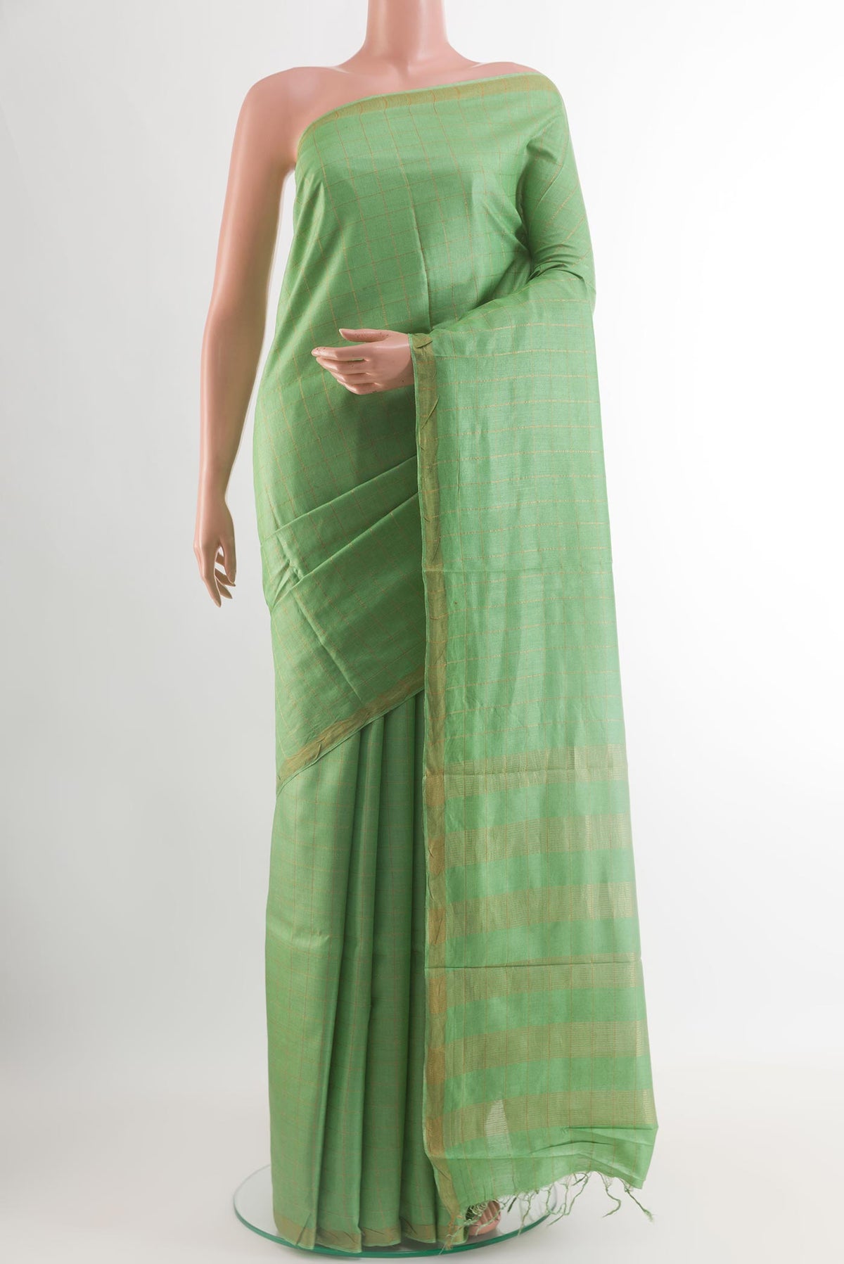 Light Green Tussar Silk Saree with Checked design on the body and Zari Border.  displayed on a mannequin