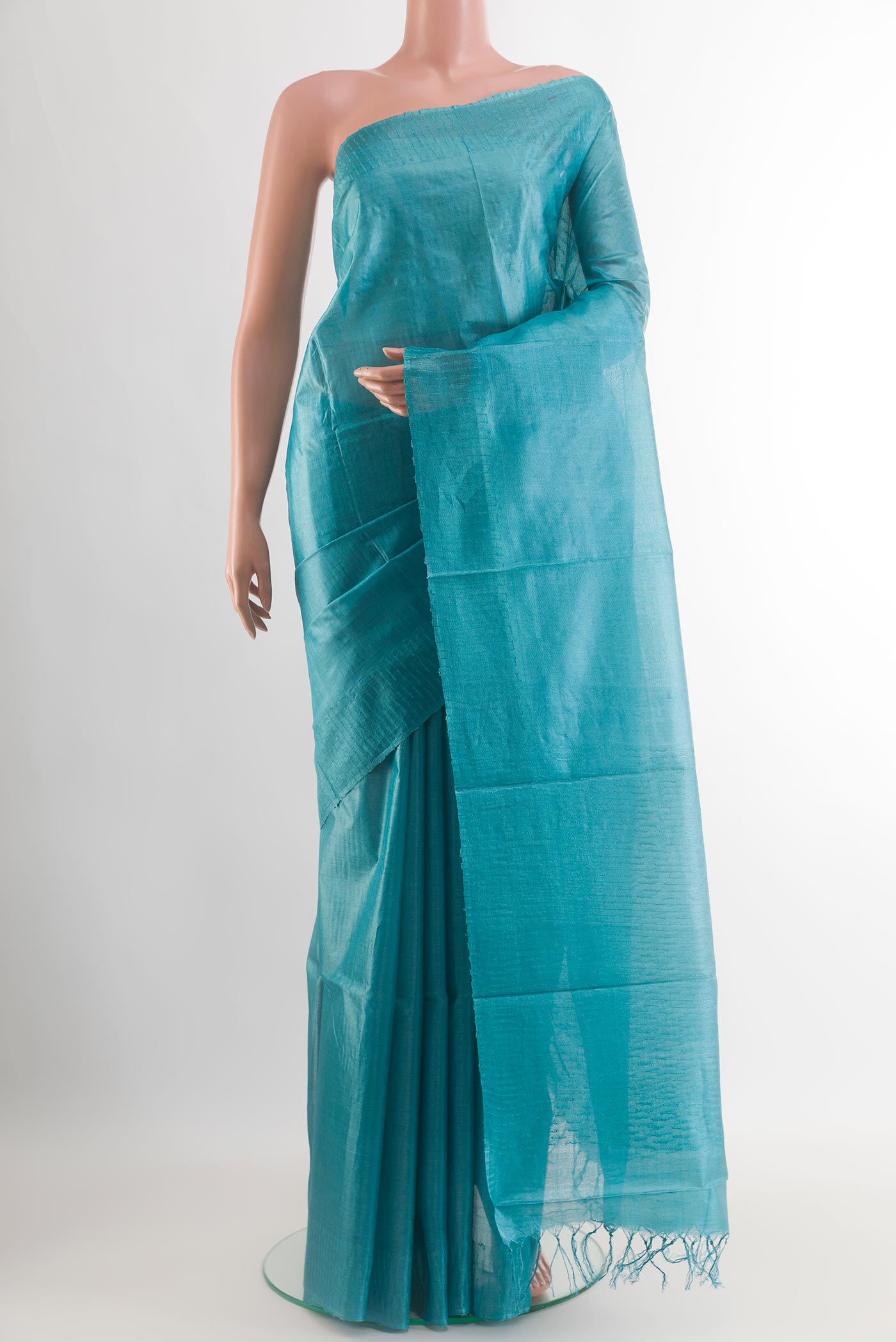 Blue Tussar Silk Saree with Plain Body and Fancy Border.  displayed on a mannequin