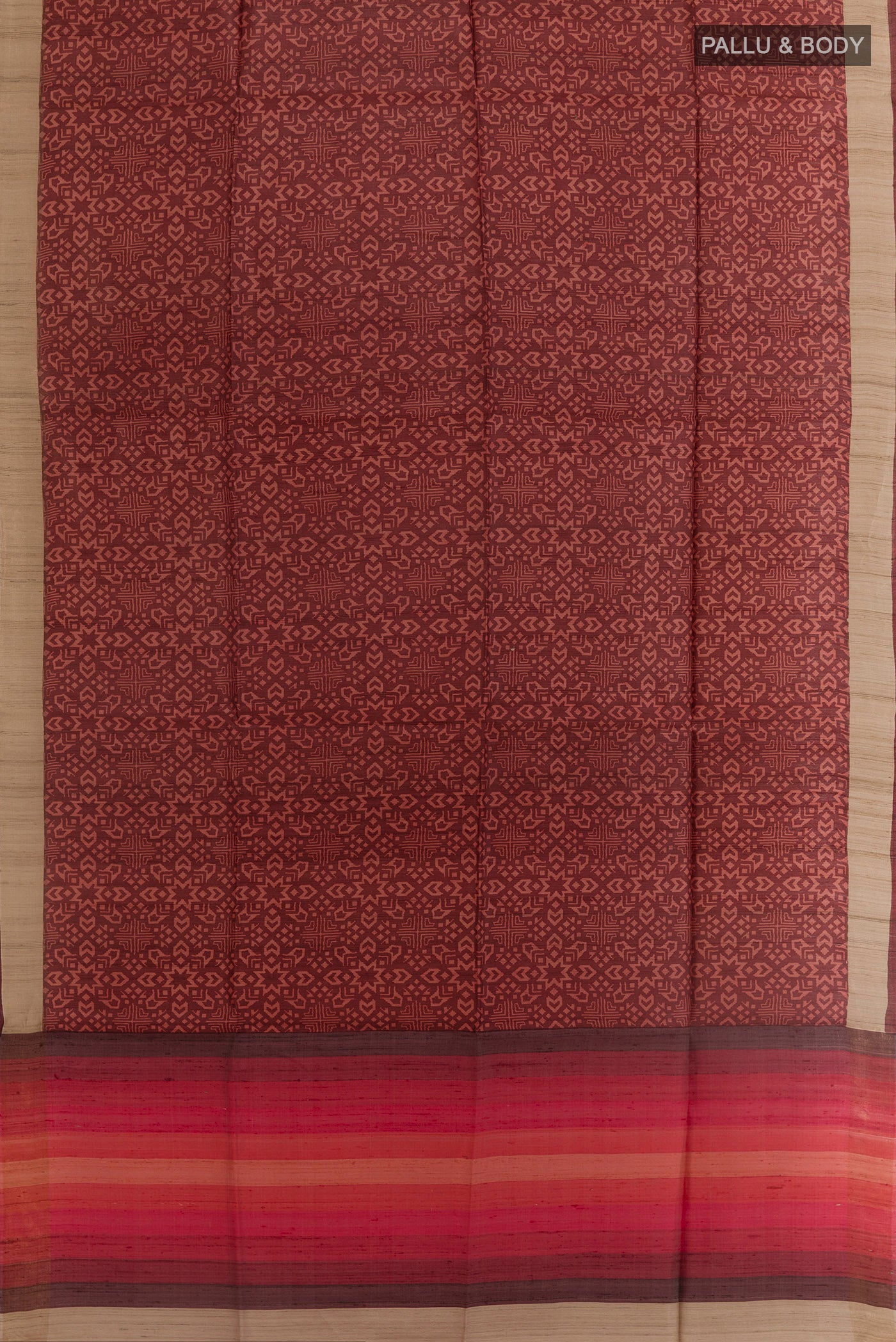Flat view of Brown Tussar Silk Saree with Printed design on the body and Zari Border. 