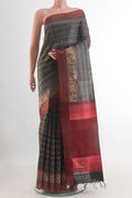 Black Tussar Silk Saree with Printed design on the body and Zari Border.  displayed on a mannequin