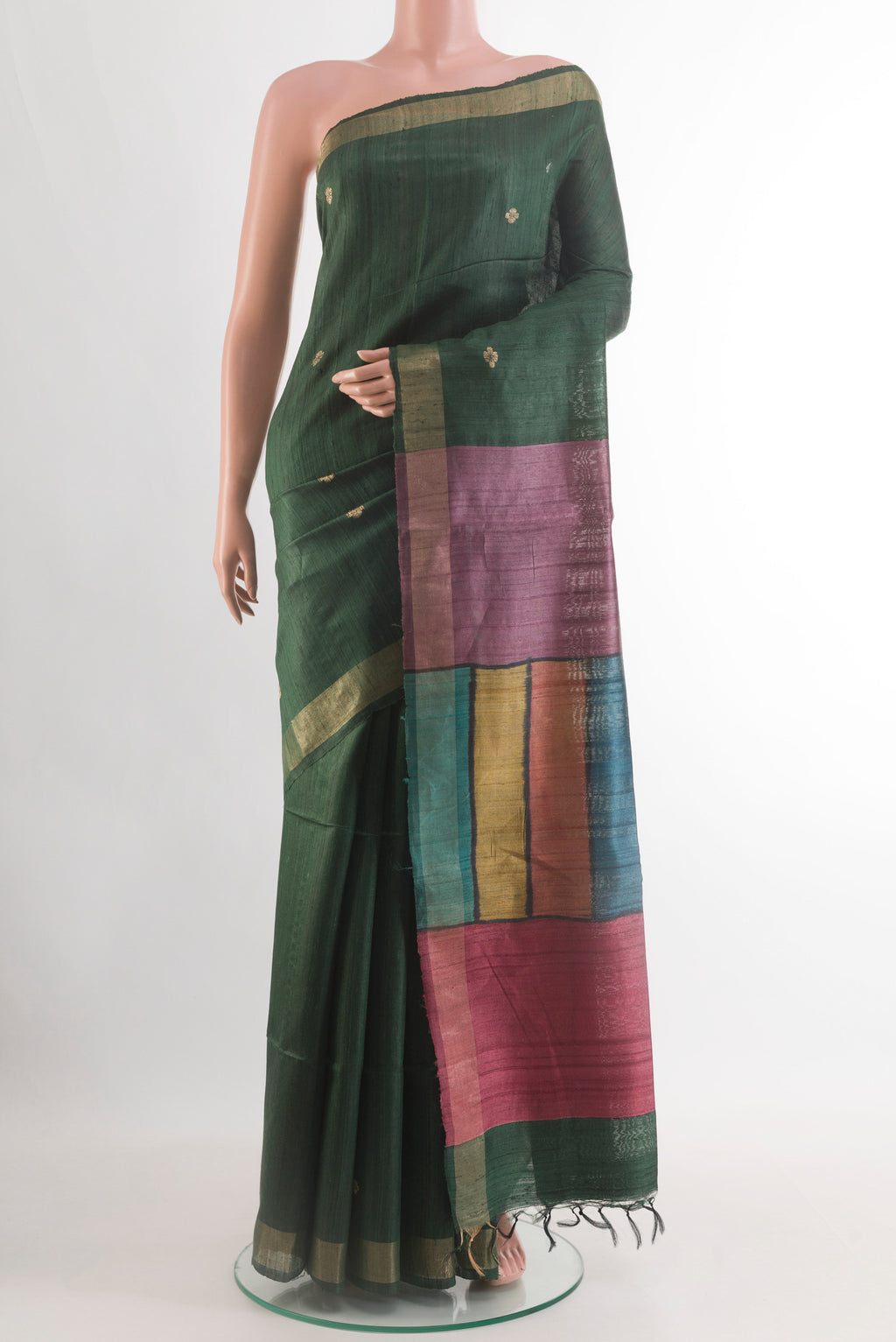 Bottle Green Tussar Silk Saree with Zari Butta on the body and Zari Border.  displayed on a mannequin