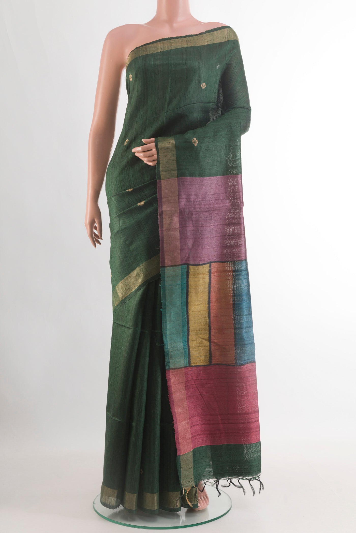 Bottle Green Tussar Silk Saree with Zari Butta on the body and Zari Border.  displayed on a mannequin