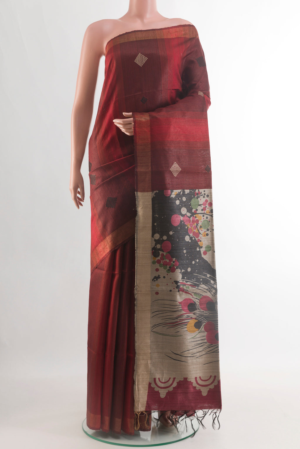 Rust Tussar Silk Saree with Thread Butta on the body and Zari Border.  displayed on a mannequin