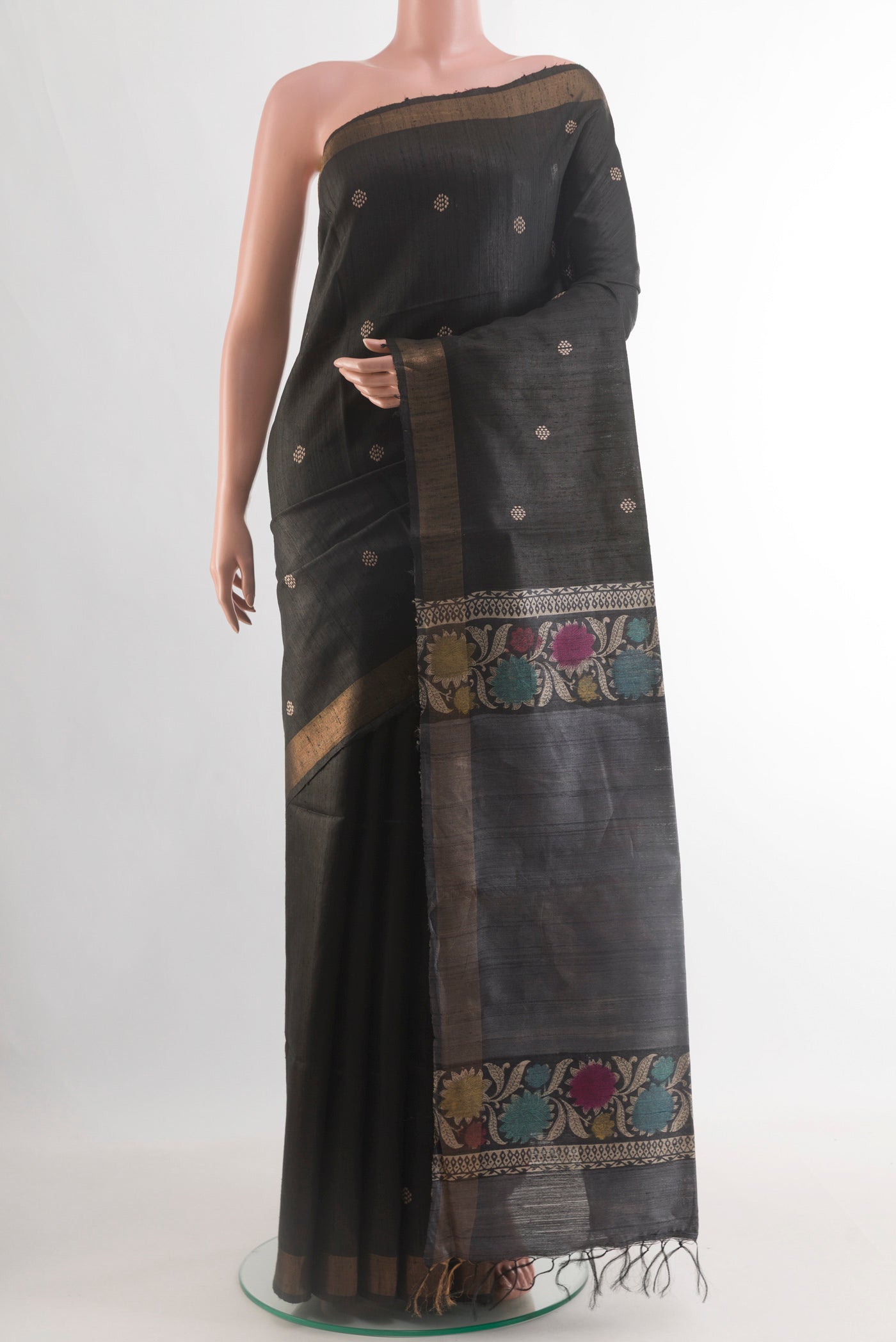 Black Tussar Silk Saree with Thread Butta on the body and Zari Border.  displayed on a mannequin