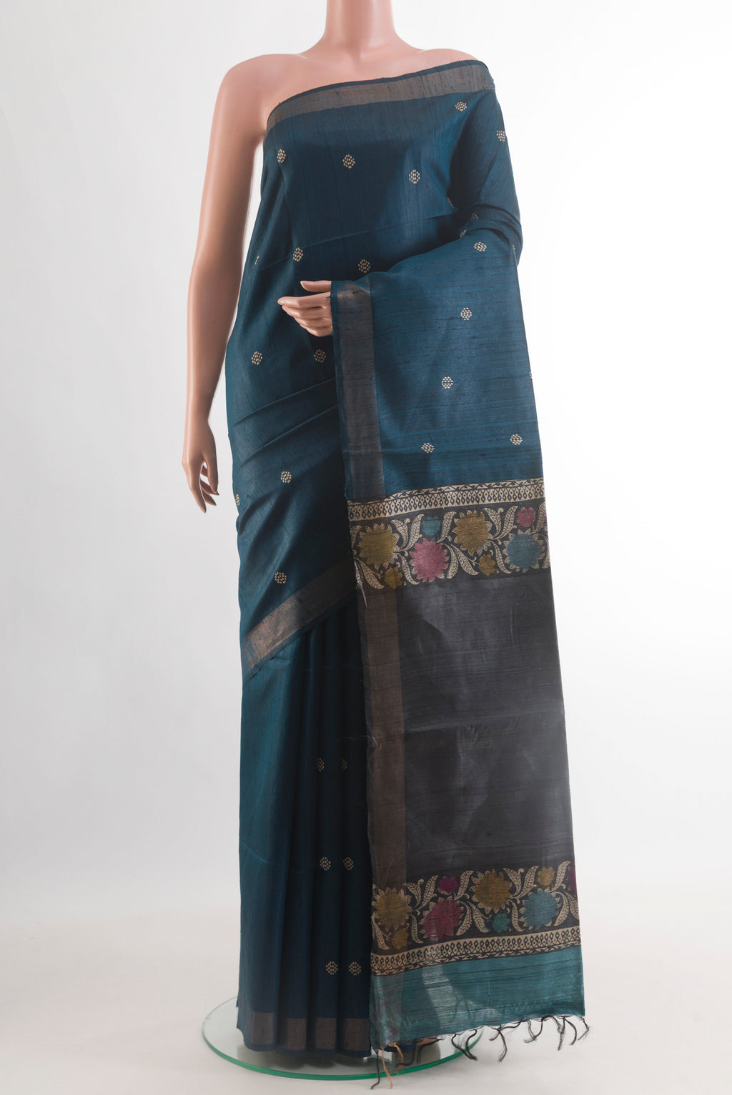 Blue Tussar Silk Saree with Thread Butta on the body and Zari Border.  displayed on a mannequin