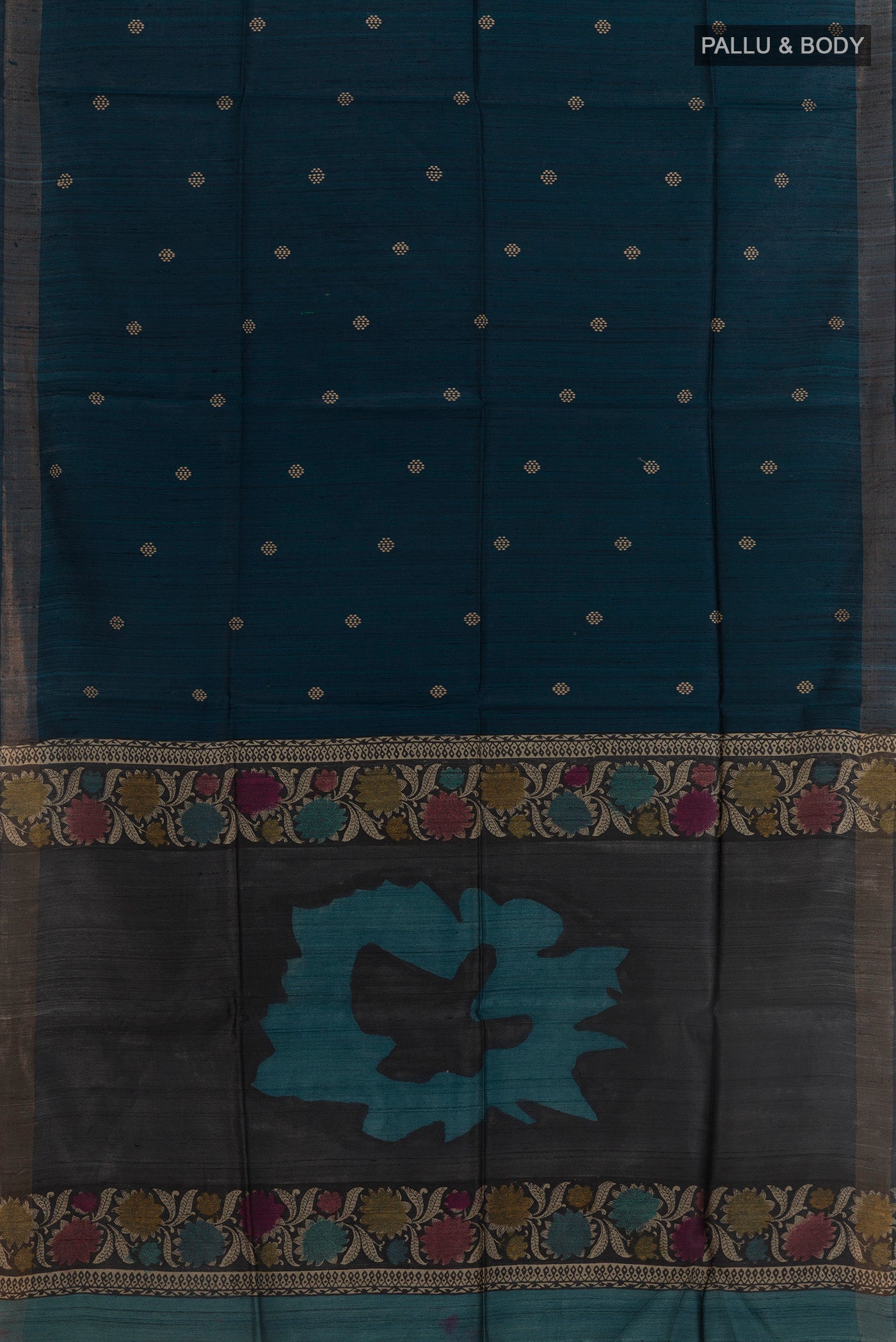 Flat view of Blue Tussar Silk Saree with Thread Butta on the body and Zari Border. 