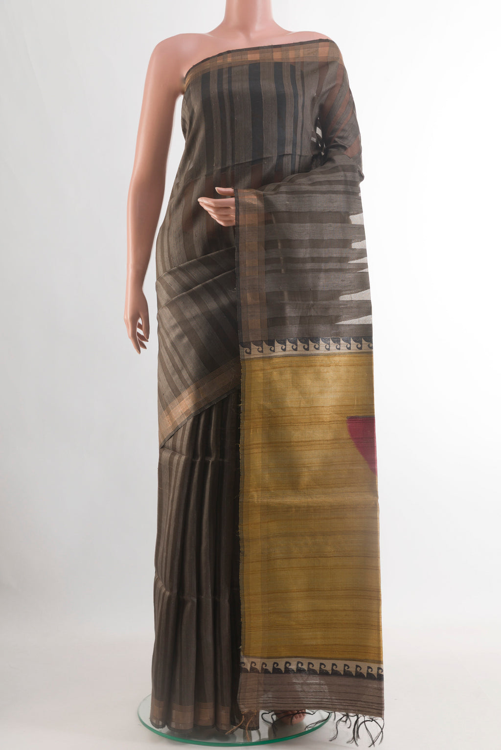 Grey Tussar Silk Saree with Stripes on the body and Zari Border.  displayed on a mannequin