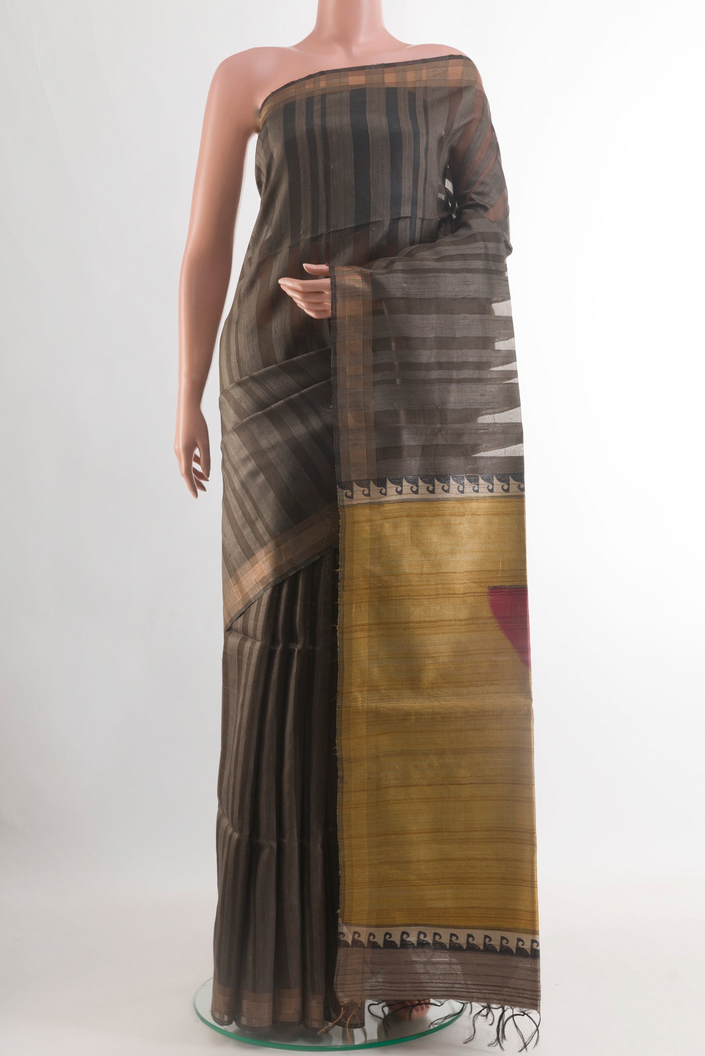 Grey Tussar Silk Saree with Stripes on the body and Zari Border.  displayed on a mannequin