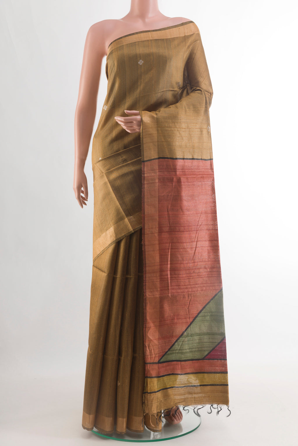 Gold Tussar Silk Saree with Zari Butta on the body and Zari Border.  displayed on a mannequin