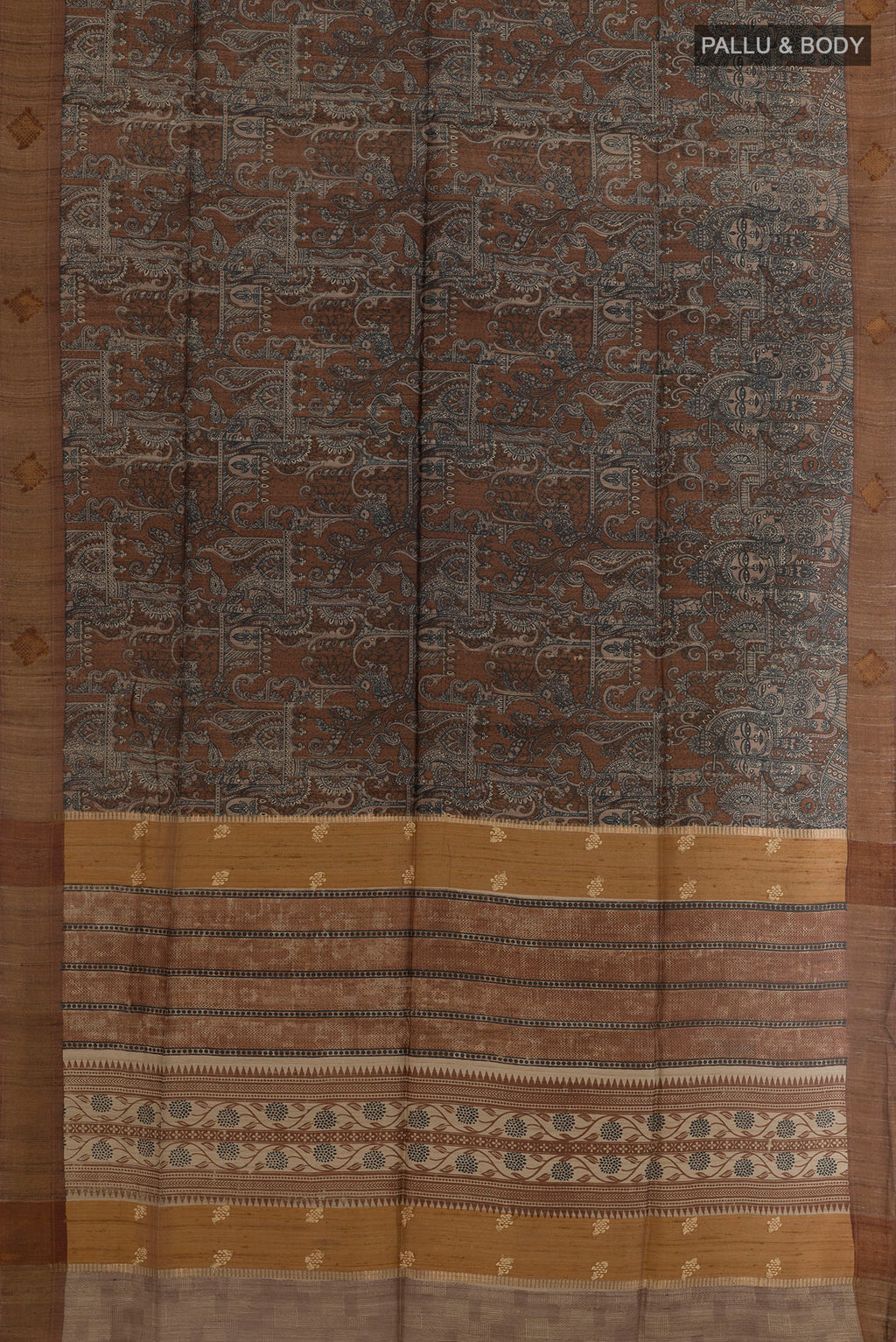 Flat view of Brown Tussar Silk Saree with Printed design on the body and Zari Border. 