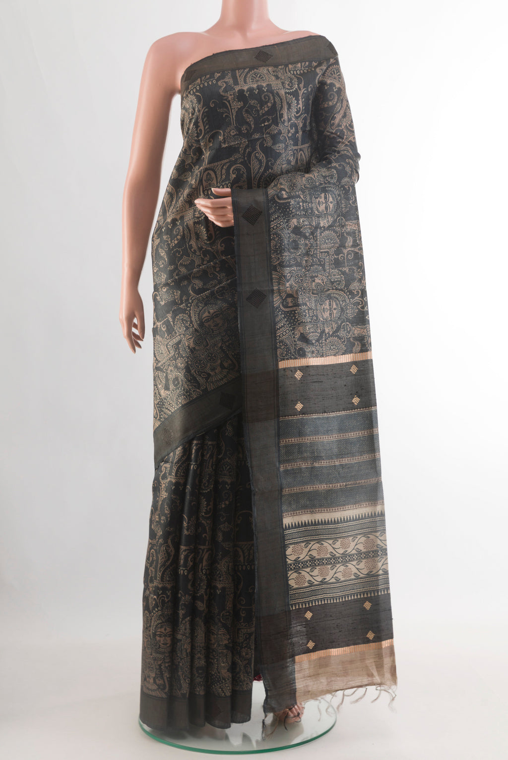 Black Tussar Silk Saree with Printed design on the body and Zari Border.  displayed on a mannequin