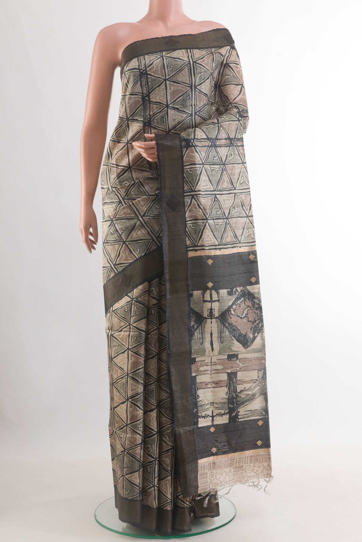Beige Tussar Silk Saree with Printed design on the body and Zari Border.  displayed on a mannequin