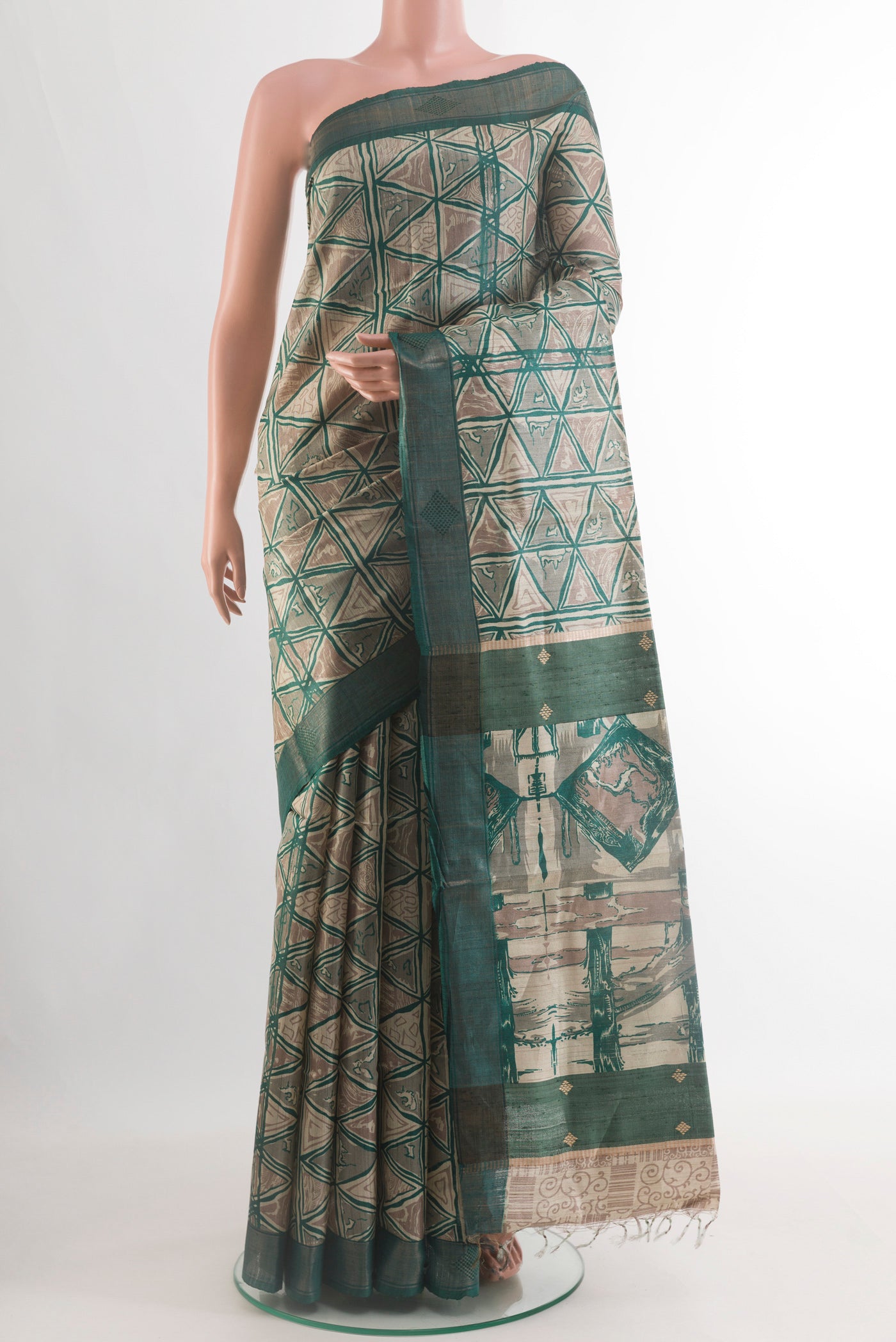 Beige Tussar Silk Saree with Printed design on the body and Zari Border.  displayed on a mannequin