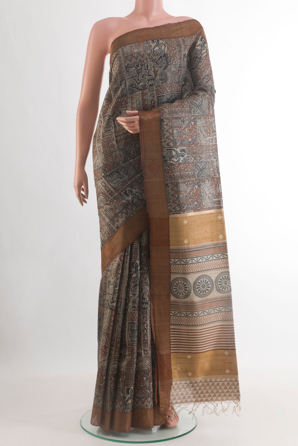 Brown Tussar Saree with Printed design on the body and Zari Border.  displayed on a mannequin