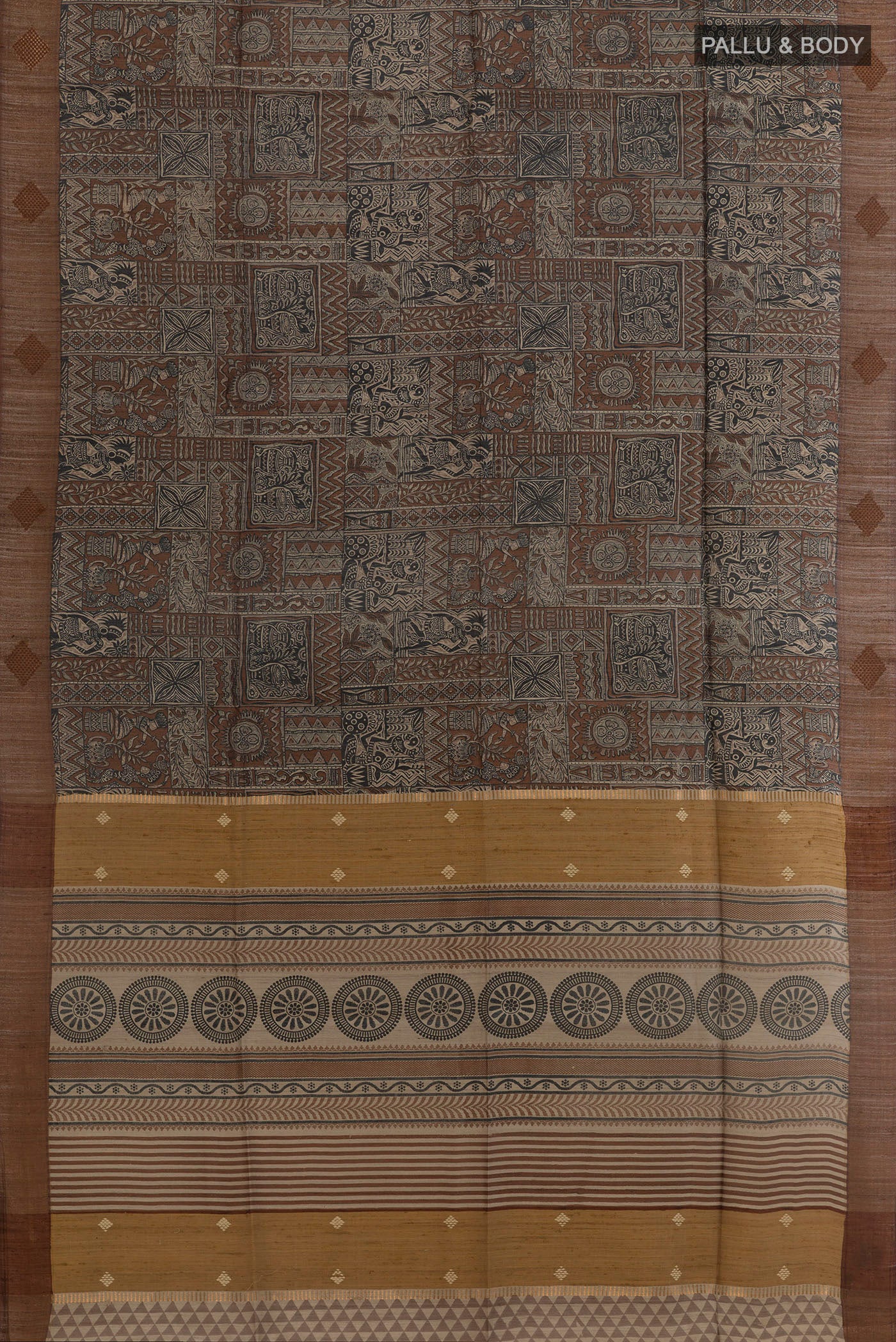 Flat view of Brown Tussar Saree with Printed design on the body and Zari Border. 